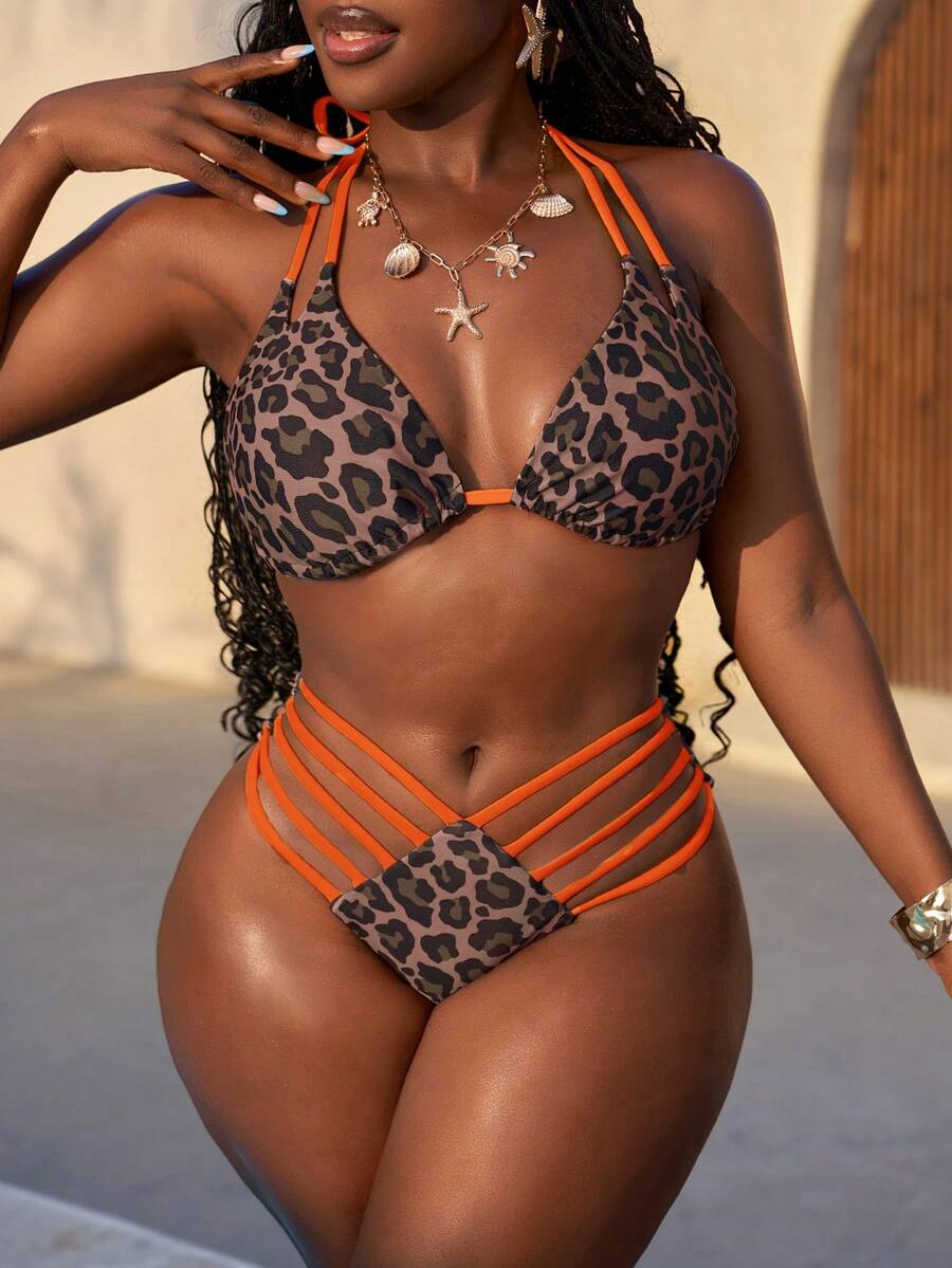 Women's leopard print bikini set featuring a halter push-up top and high-waisted cut out bottoms with tie back detail.