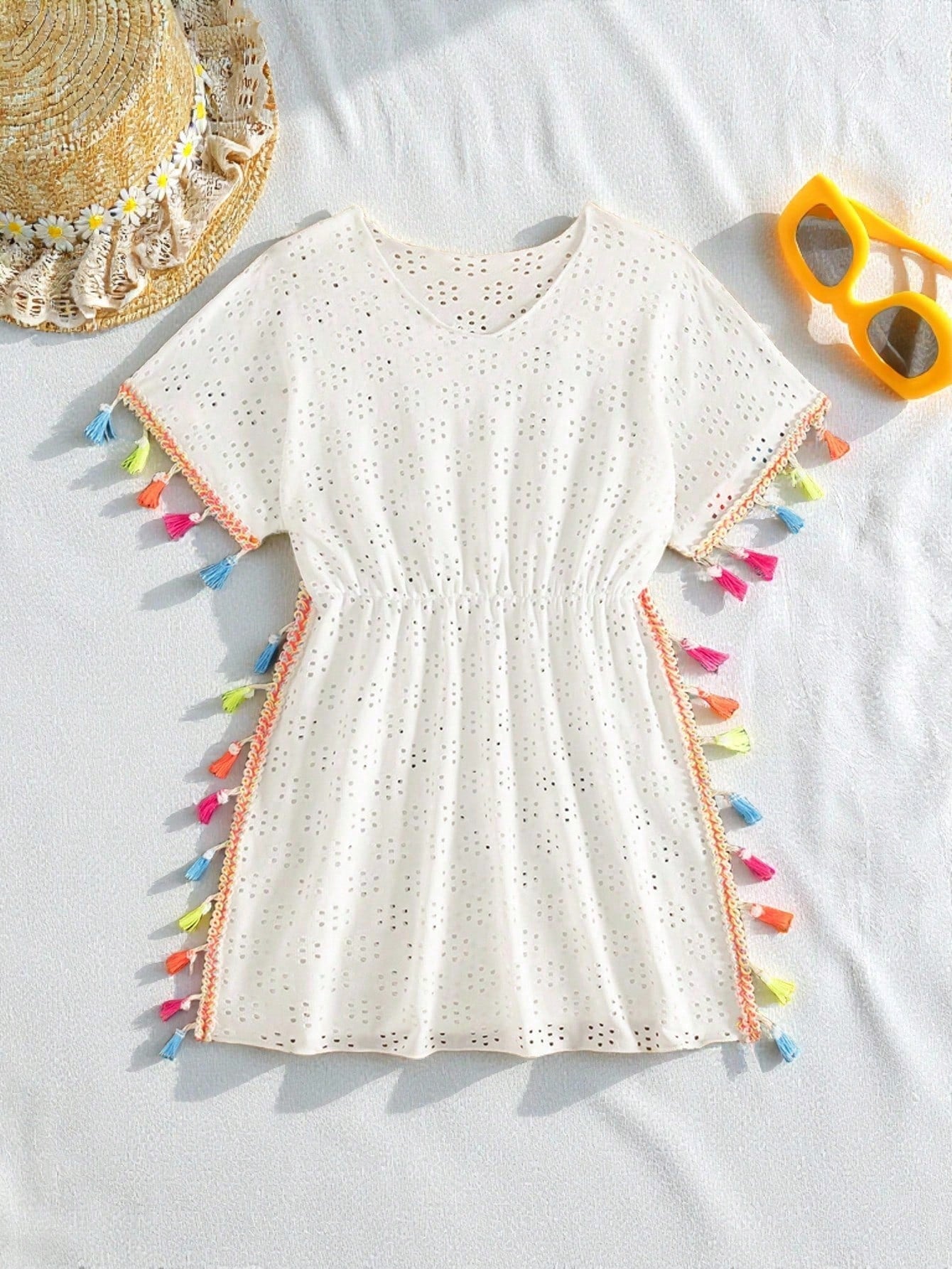 Tween girl white swimsuit cover up with colorful tassel fringe, hollow crochet mesh, round neck, short sleeves, and semi-sheer beach dress style.