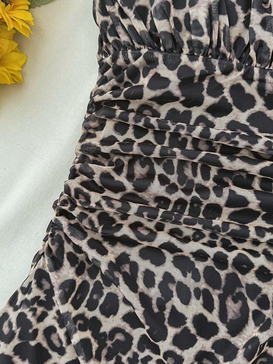 Tween girl yellow mini sundress with large pink floral hibiscus print, spaghetti straps, high waist, flared hem, and sleeveless cami style for summer beach wear