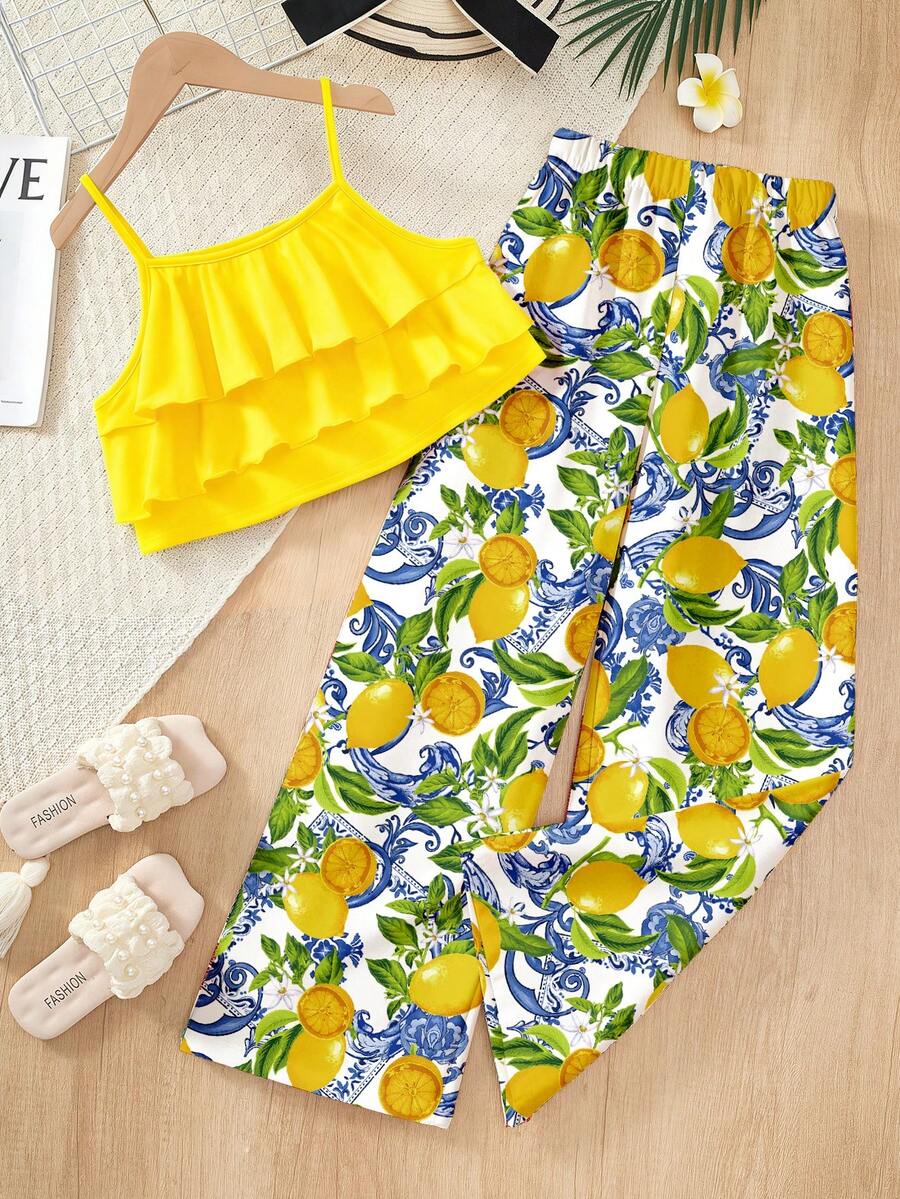 Tween girls blue 2-piece vacation outfit set featuring a tiered ruffle spaghetti strap camisole and loose high-waist pants.