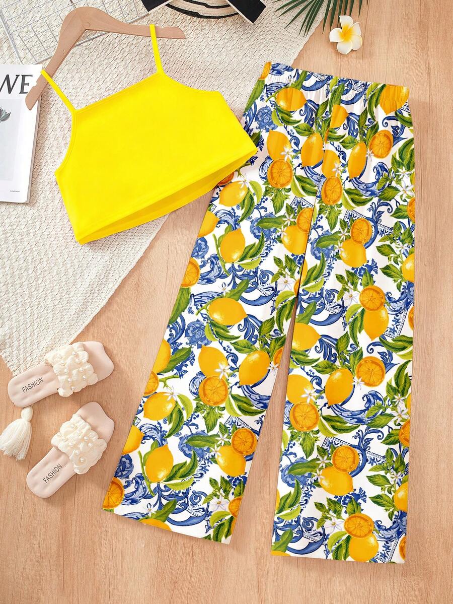 Tween girls blue 2-piece vacation outfit set featuring a tiered ruffle spaghetti strap camisole and loose high-waist pants.