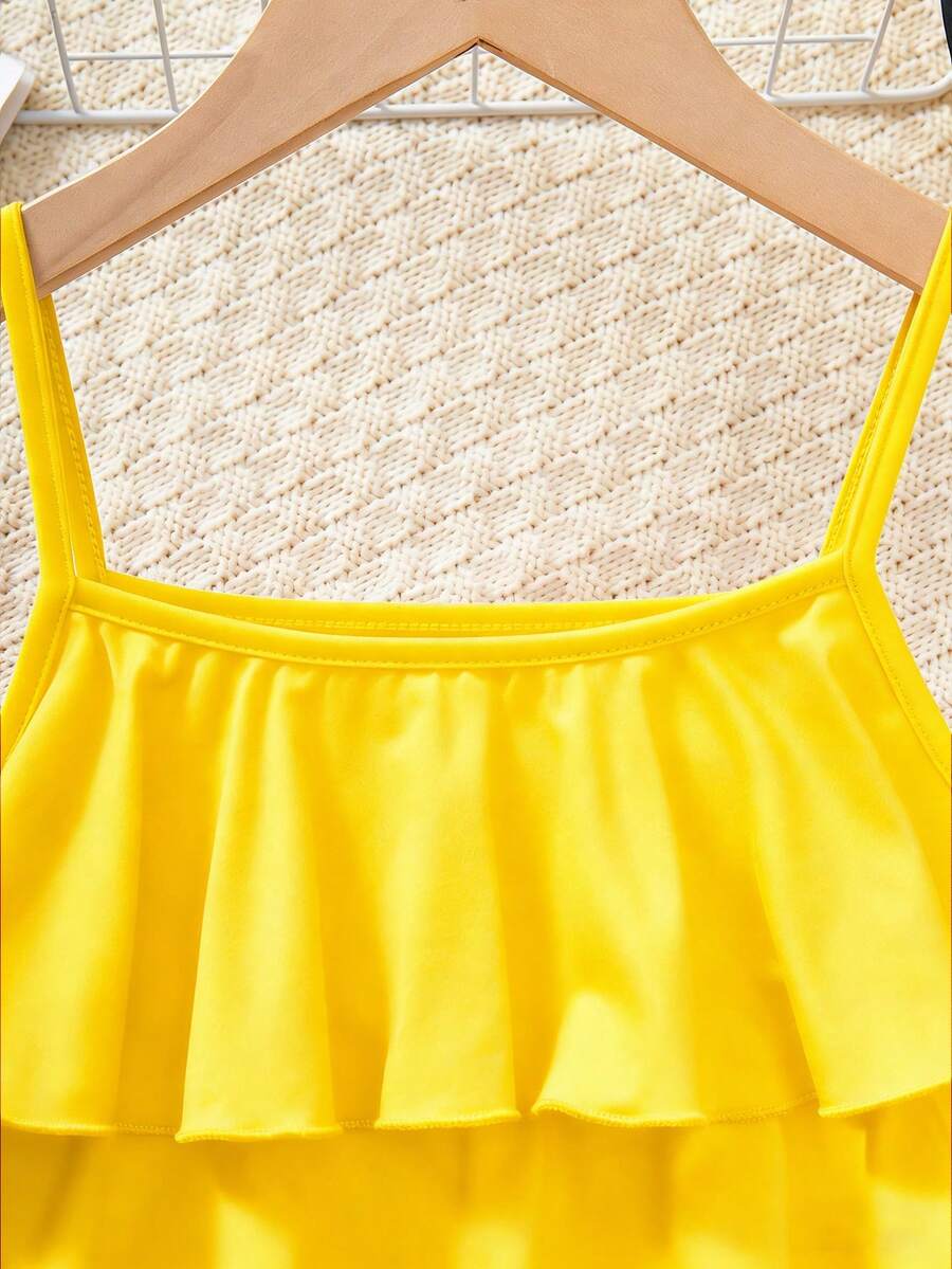 Tween girls blue 2-piece vacation outfit set featuring a tiered ruffle spaghetti strap camisole and loose high-waist pants.