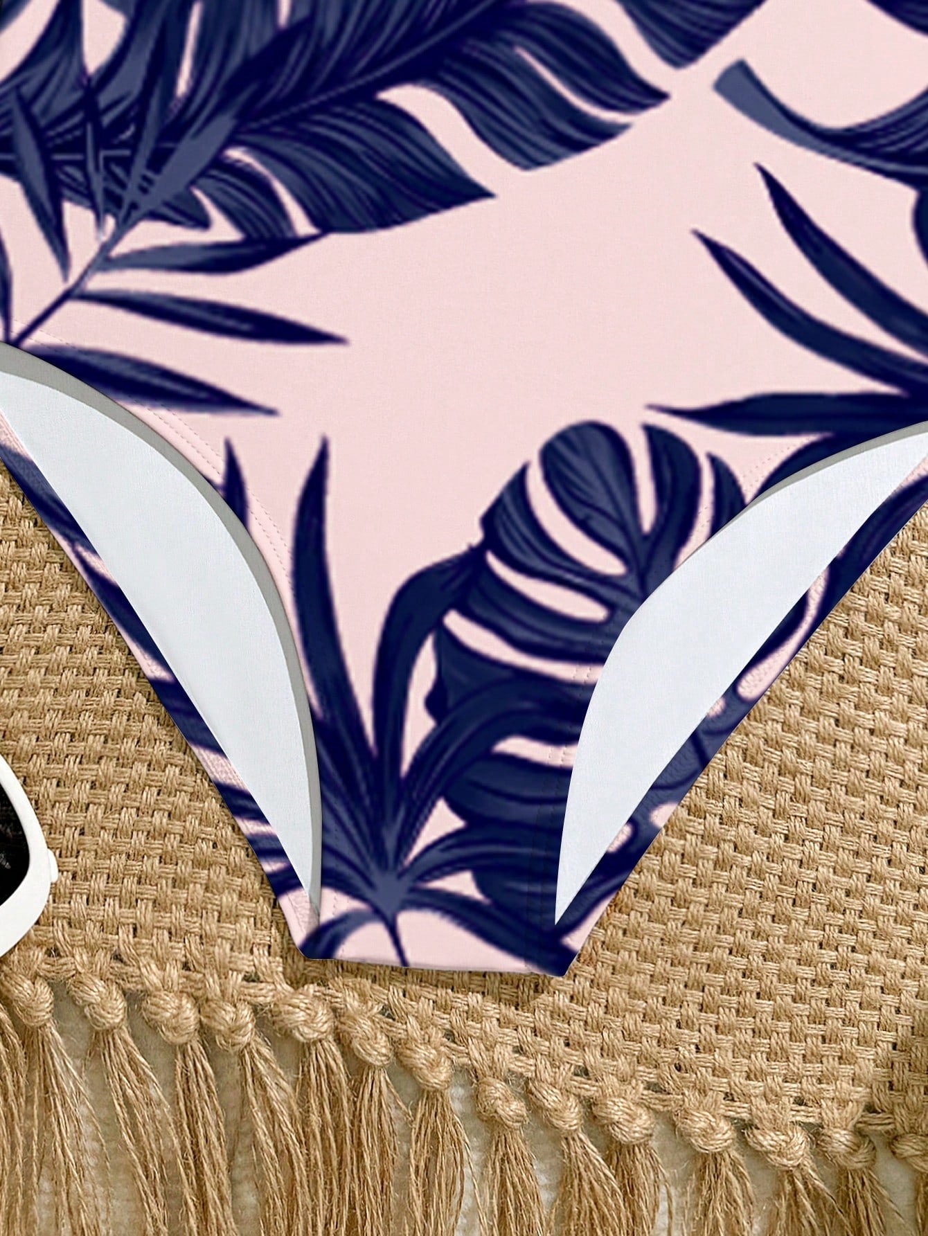 Tween girls one-piece swimsuit with a floral plant print, spaghetti straps, and a mid-waist fit in black.