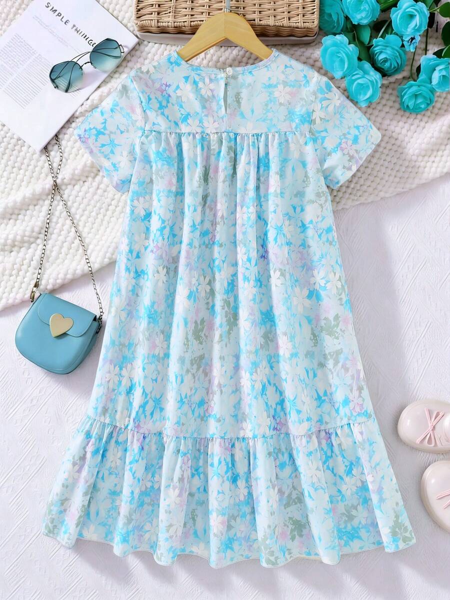 Tween girl wearing an Army Green textured short sleeve smock midi dress with round neck and ruffle flounce hem.