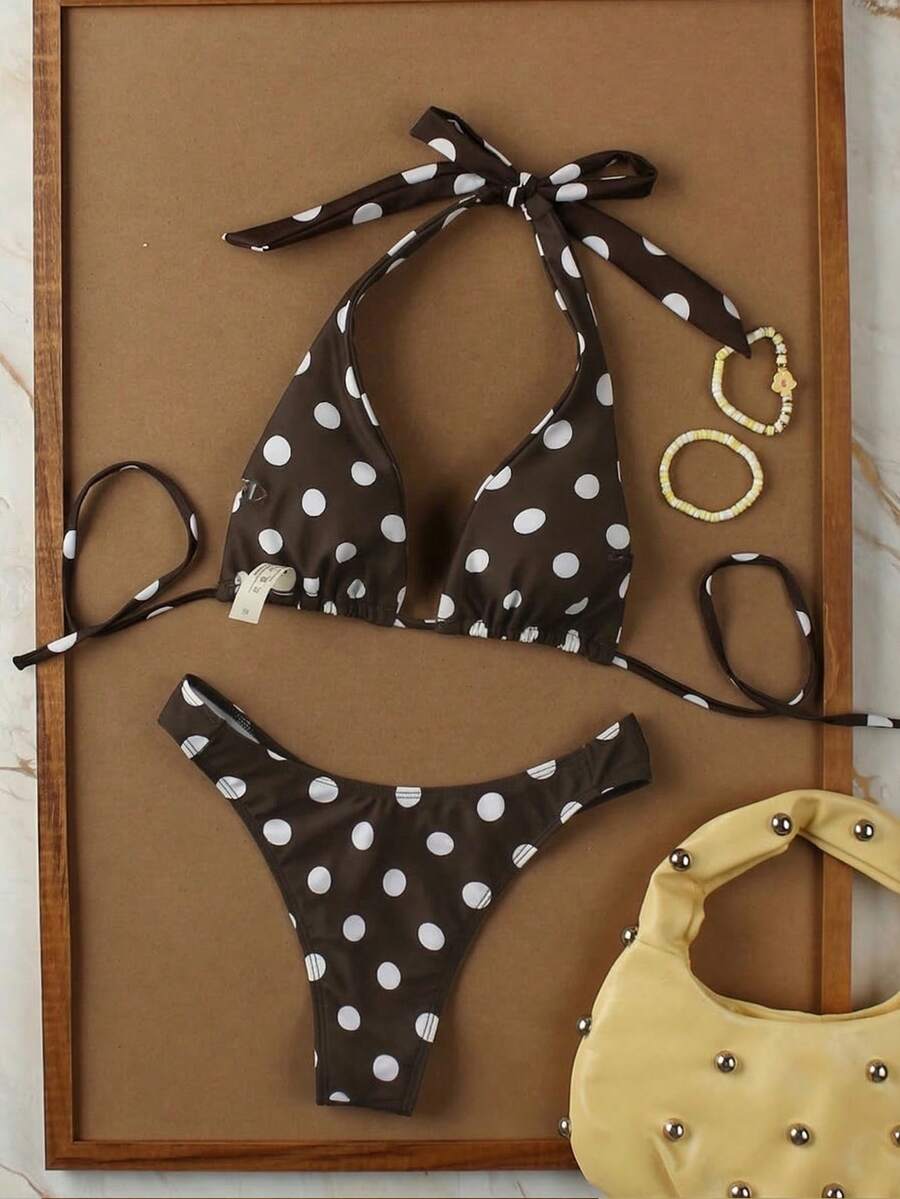 Women's halter neck bikini swimwear set featuring a wireless bra top with removable padding and mid waist bikini bottom.