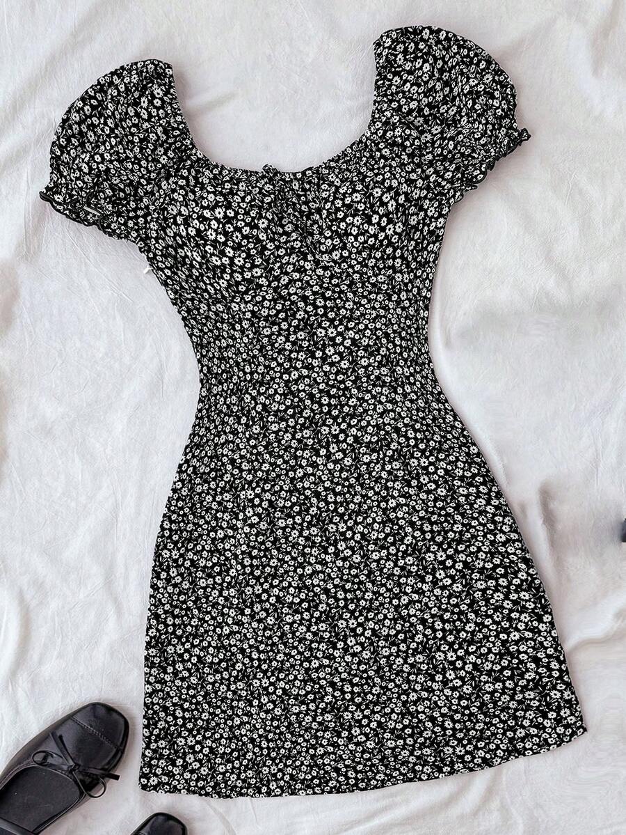 Black floral all-over print midi dress for tween girls featuring puff half sleeves, spaghetti strap neckline, and an A-line silhouette.