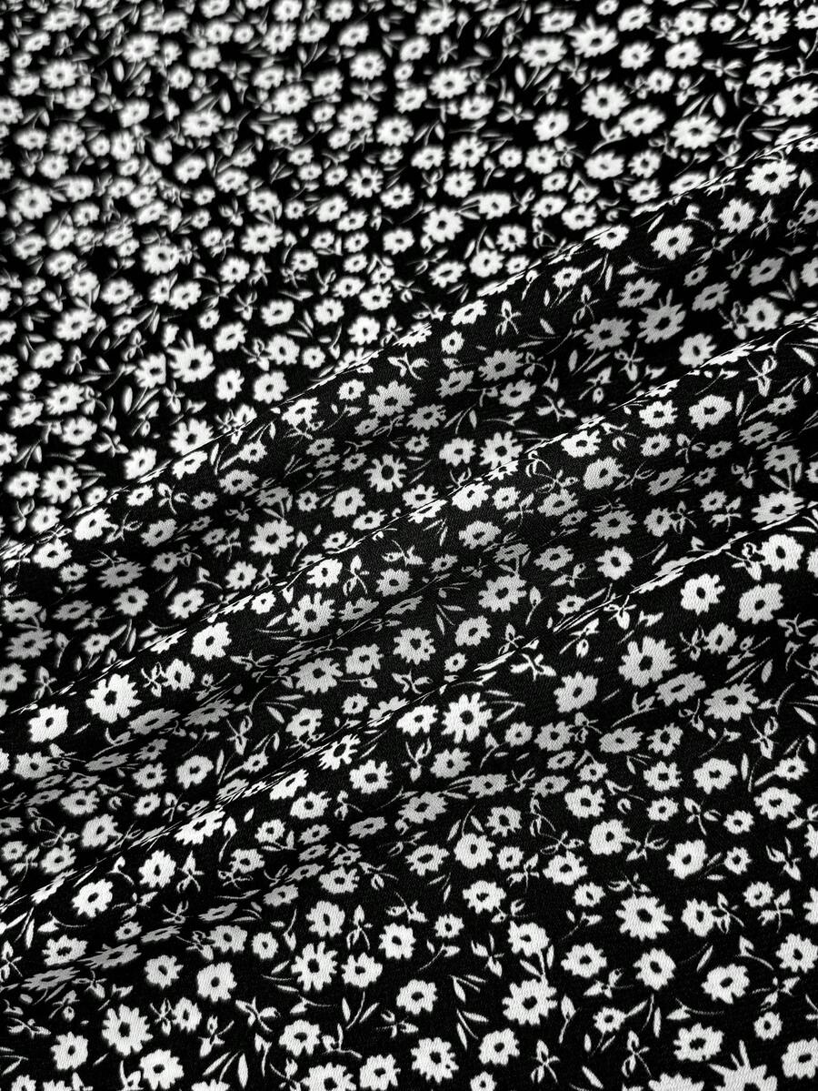 Black floral all-over print midi dress for tween girls featuring puff half sleeves, spaghetti strap neckline, and an A-line silhouette.
