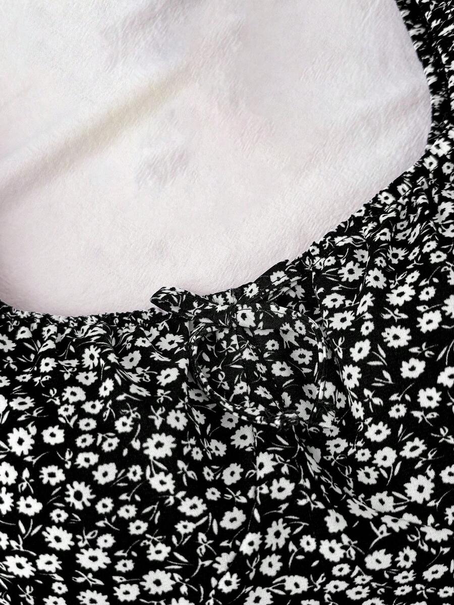 Black floral all-over print midi dress for tween girls featuring puff half sleeves, spaghetti strap neckline, and an A-line silhouette.