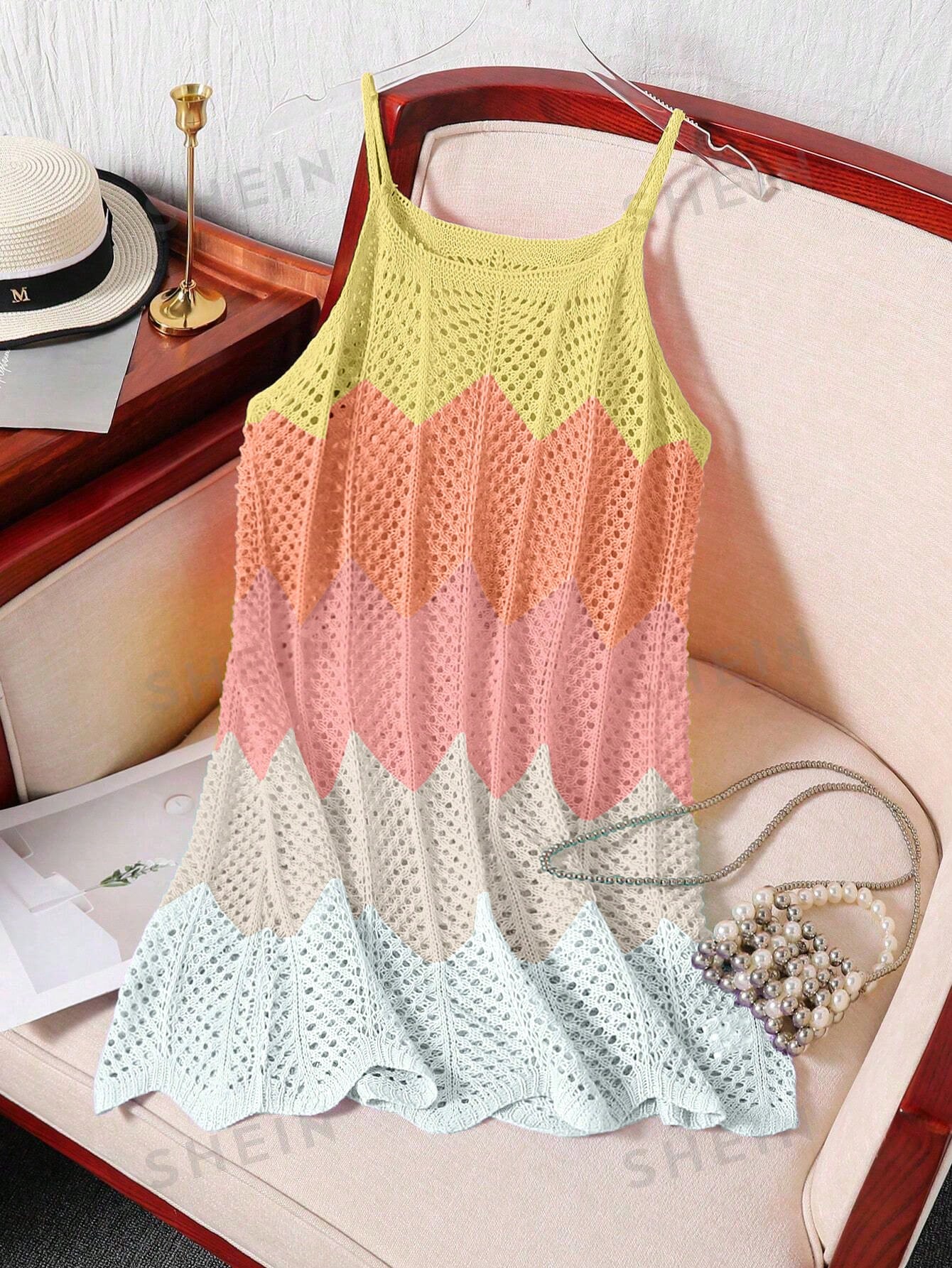 Girls' multicolor rainbow gradient crochet beach cover up with hollow-out knit design, spaghetti straps, sleeveless A-line shape, and semi-sheer finish.