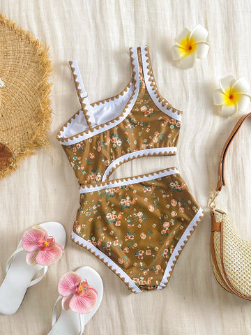 Multicolor floral one-piece swimsuit for tween girls with spaghetti straps, ruffle trim, cut-out detail, contrast piping, and fitted vacation swimwear style.