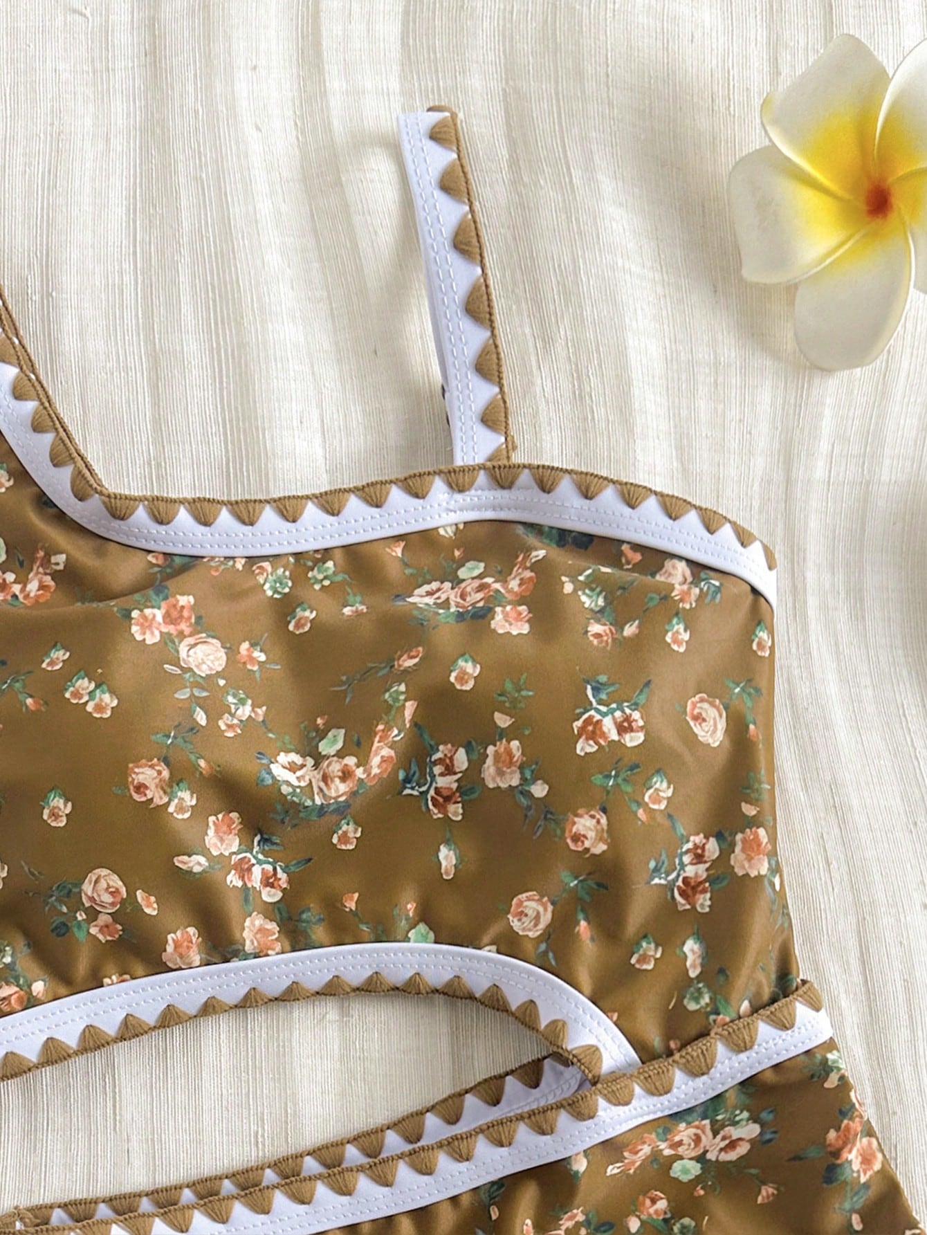 Tween girls one-piece swimsuit featuring an asymmetric neckline, pendant decor, plain design, wireless bra, high-cut bottom, and medium-stretch fabric.
