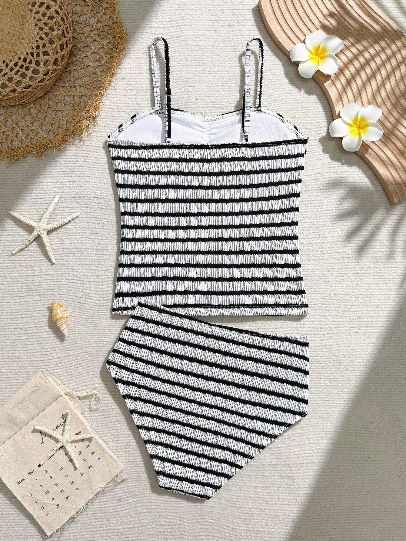 Tween girls 2-piece bikini swimwear set in black with a wave-pattern geometric design, featuring halter neckline, wireless top, and high-waist short bottoms with starfish and shell decor.