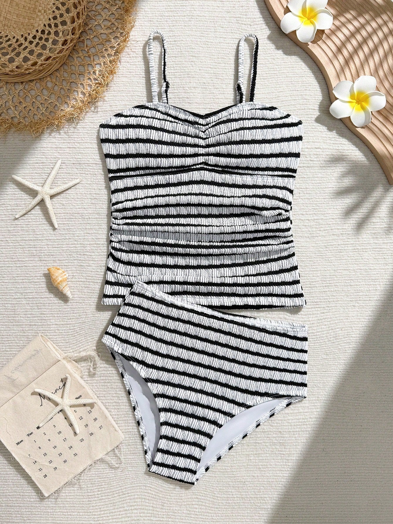 Tween girls 2-piece bikini swimwear set in black with a wave-pattern geometric design, featuring halter neckline, wireless top, and high-waist short bottoms with starfish and shell decor.