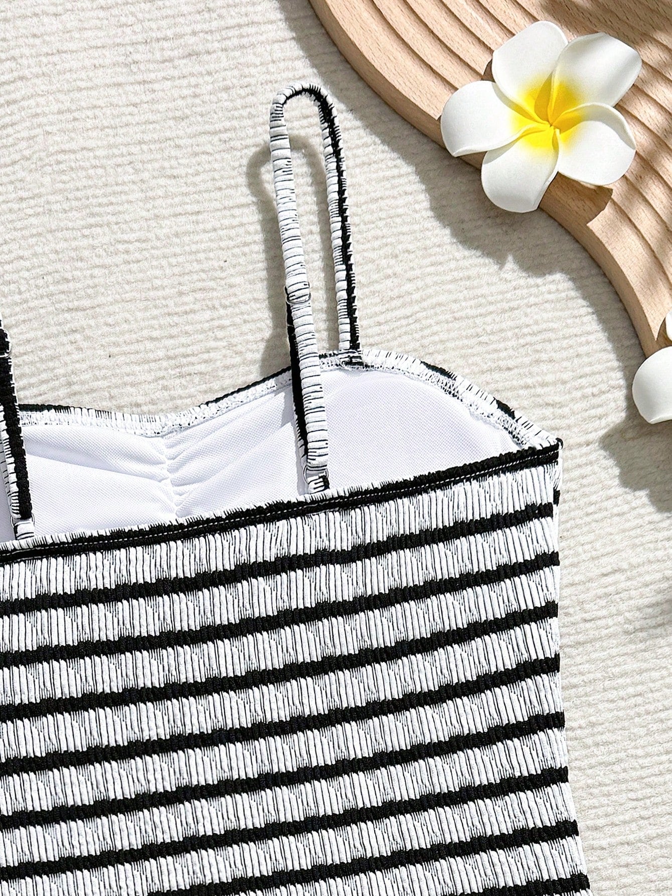 Tween girls 2-piece bikini swimwear set in black with a wave-pattern geometric design, featuring halter neckline, wireless top, and high-waist short bottoms with starfish and shell decor.