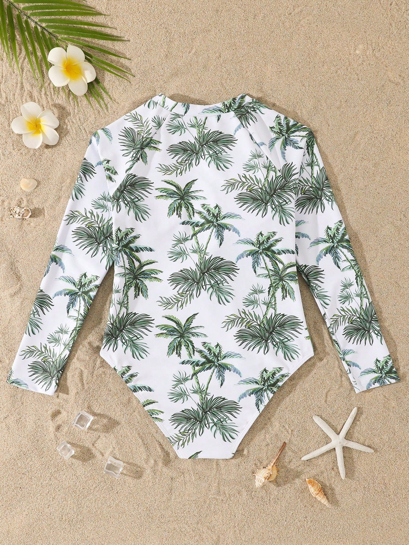 Tween girls one-piece rash guard swimsuit with long sleeves, high neck, front zipper, and ocean shell graphic print in a fitted style for beach, swimming, and vacation wear.