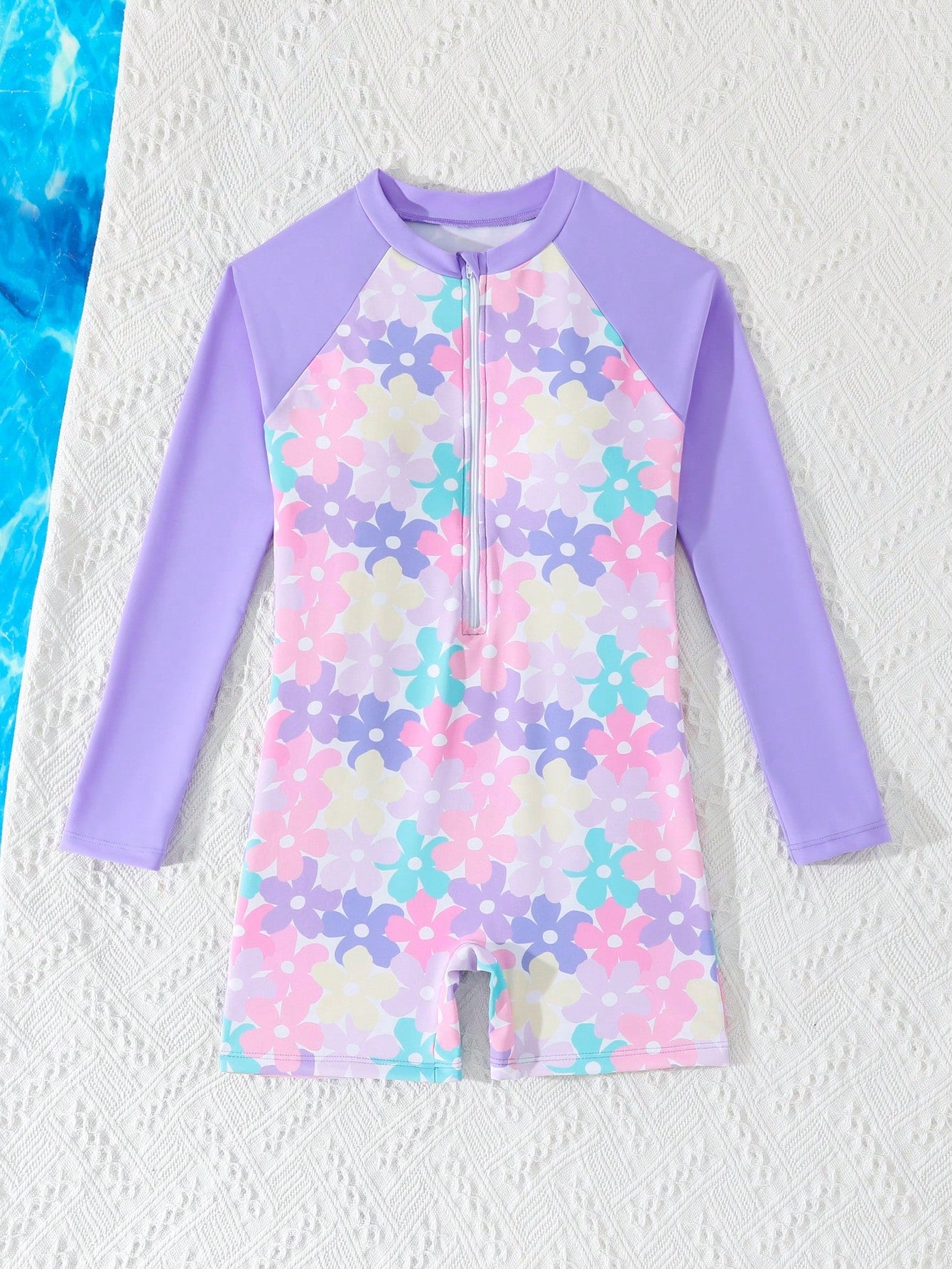Tween girls one-piece swimsuit featuring a high neck, long sleeves, and shorts bottom, with a back zipper and strawberry plaid digital print on stretch knit fabric. Designed for swimming, vacation, and summer wear.