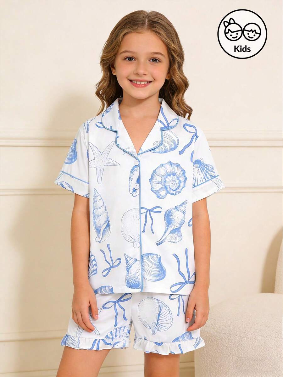 White 2-piece tween girl summer pajama set with blue ocean and seashell print featuring a short sleeve lapel cardigan top and matching elastic waist shorts.