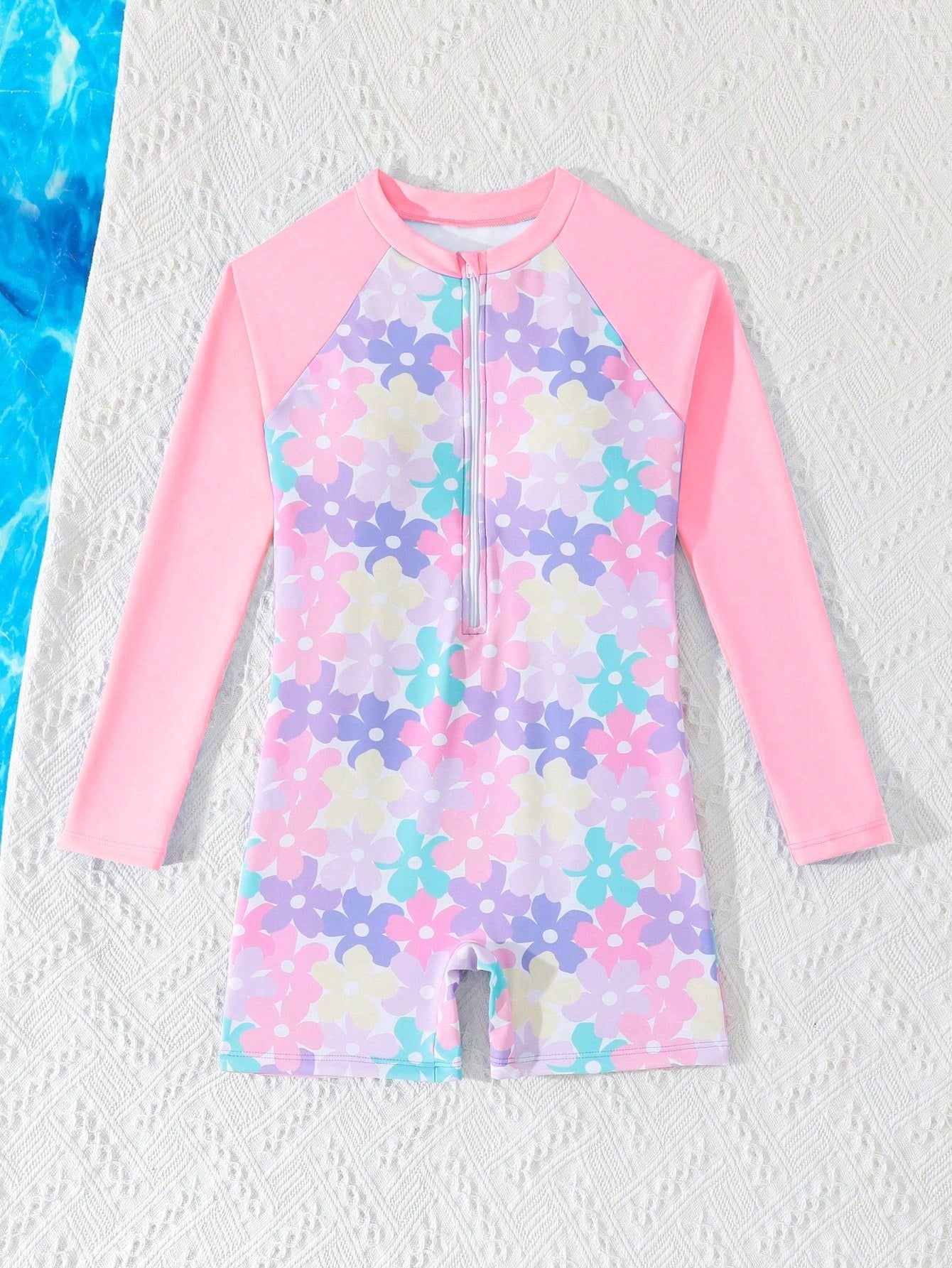 Tween girls one-piece swimsuit featuring a high neck, long sleeves, and shorts bottom, with a back zipper and strawberry plaid digital print on stretch knit fabric. Designed for swimming, vacation, and summer wear.