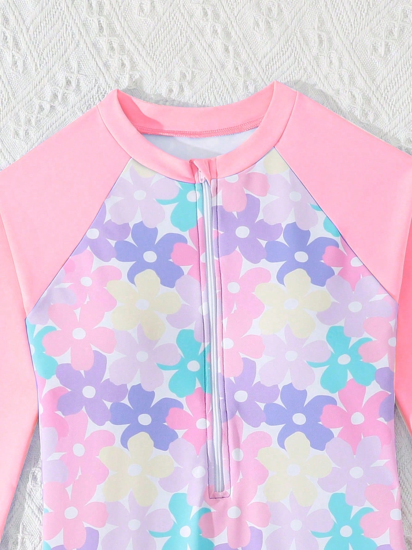 Tween girls one-piece swimsuit featuring a high neck, long sleeves, and shorts bottom, with a back zipper and strawberry plaid digital print on stretch knit fabric. Designed for swimming, vacation, and summer wear.