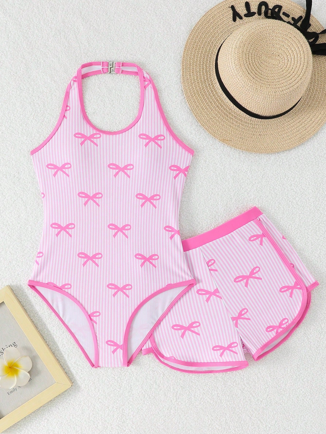 Girls 2-piece swimwear set featuring a butterfly print halter swimsuit top with contrast piping and separate mid-waist shorts; sleeveless, high-stretch, wireless design for beach and vacation wear.