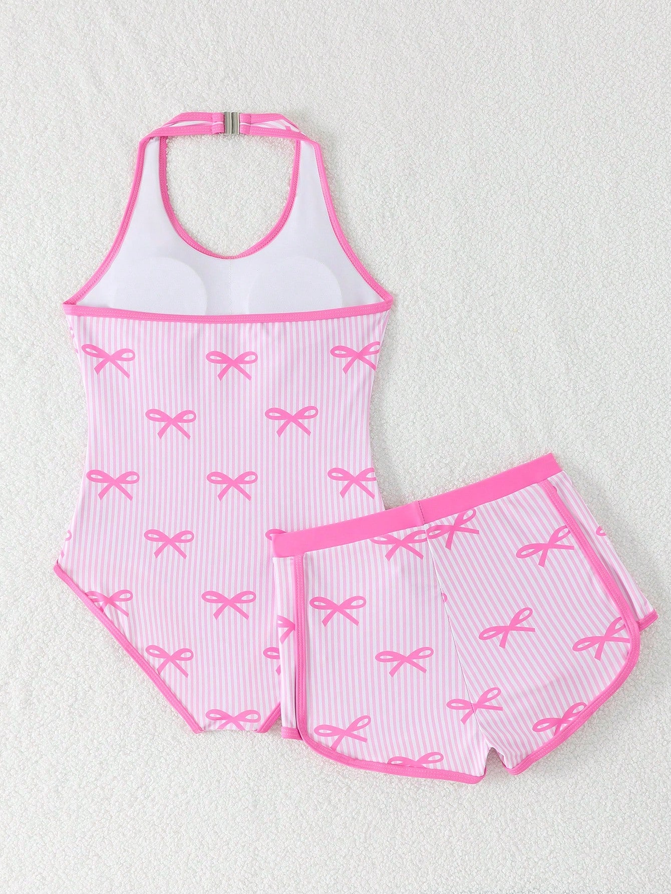 Girls 2-piece swimwear set featuring a butterfly print halter swimsuit top with contrast piping and separate mid-waist shorts; sleeveless, high-stretch, wireless design for beach and vacation wear.