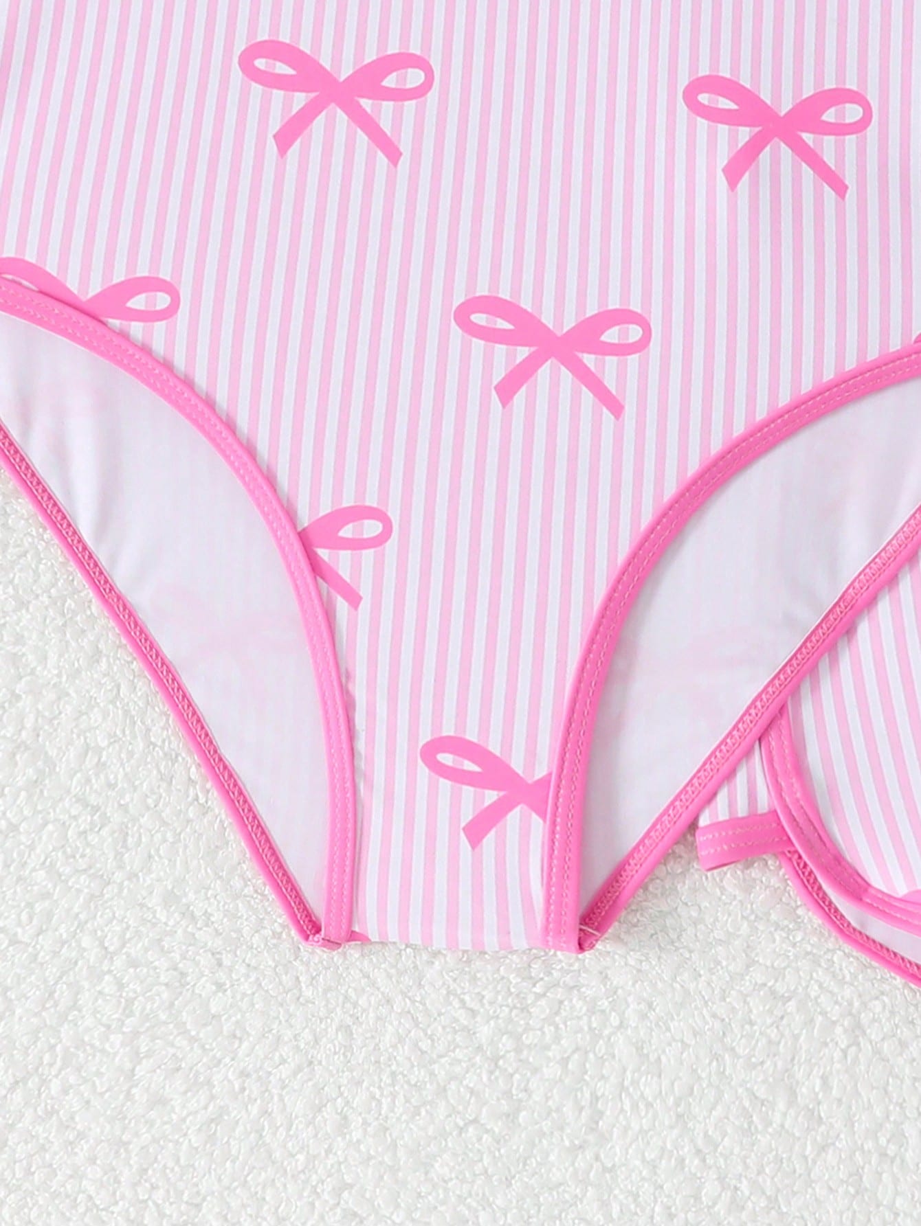 Girls 2-piece swimwear set featuring a butterfly print halter swimsuit top with contrast piping and separate mid-waist shorts; sleeveless, high-stretch, wireless design for beach and vacation wear.