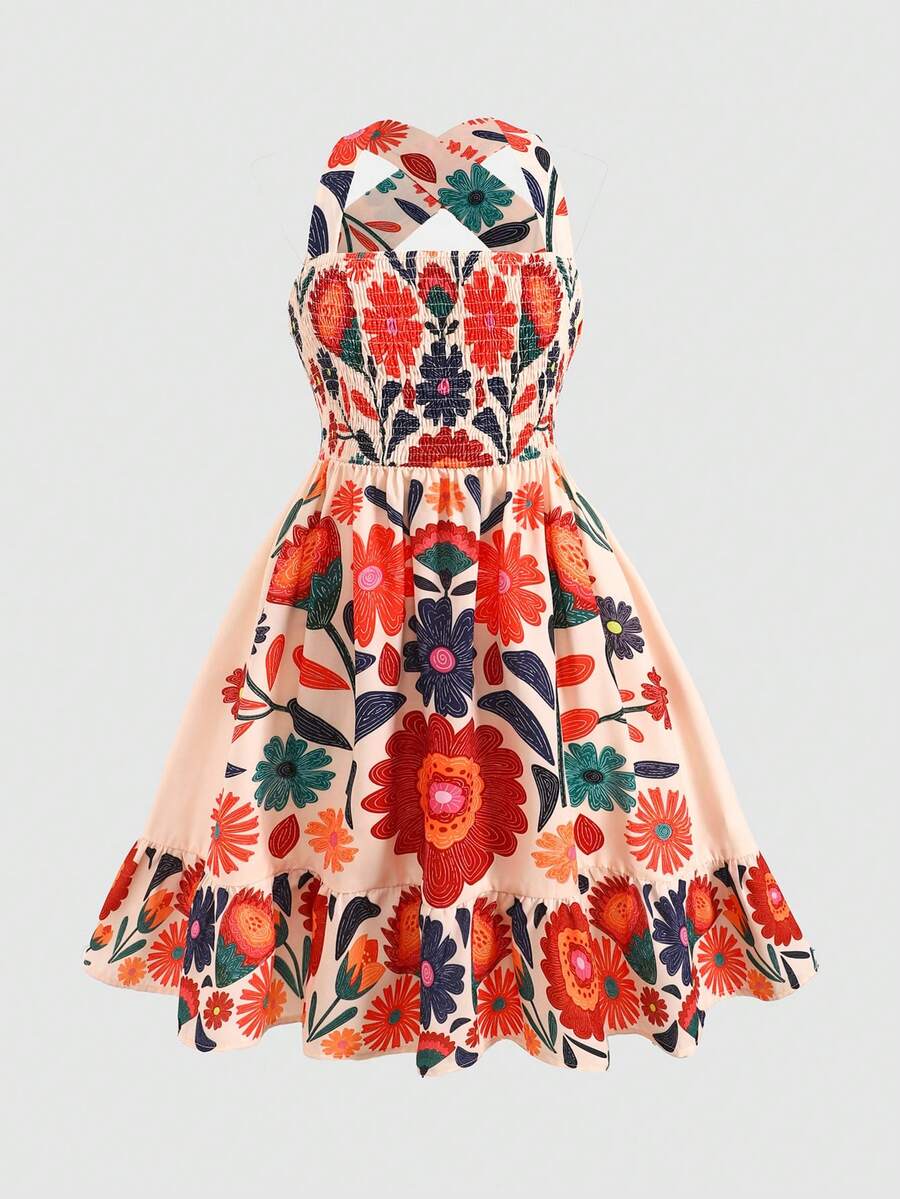 Pink sleeveless tween girls vacation dress with all-over fruit and vegetable print, strap neckline, belted high waist, cut-out detail, and flared ruffle hem.