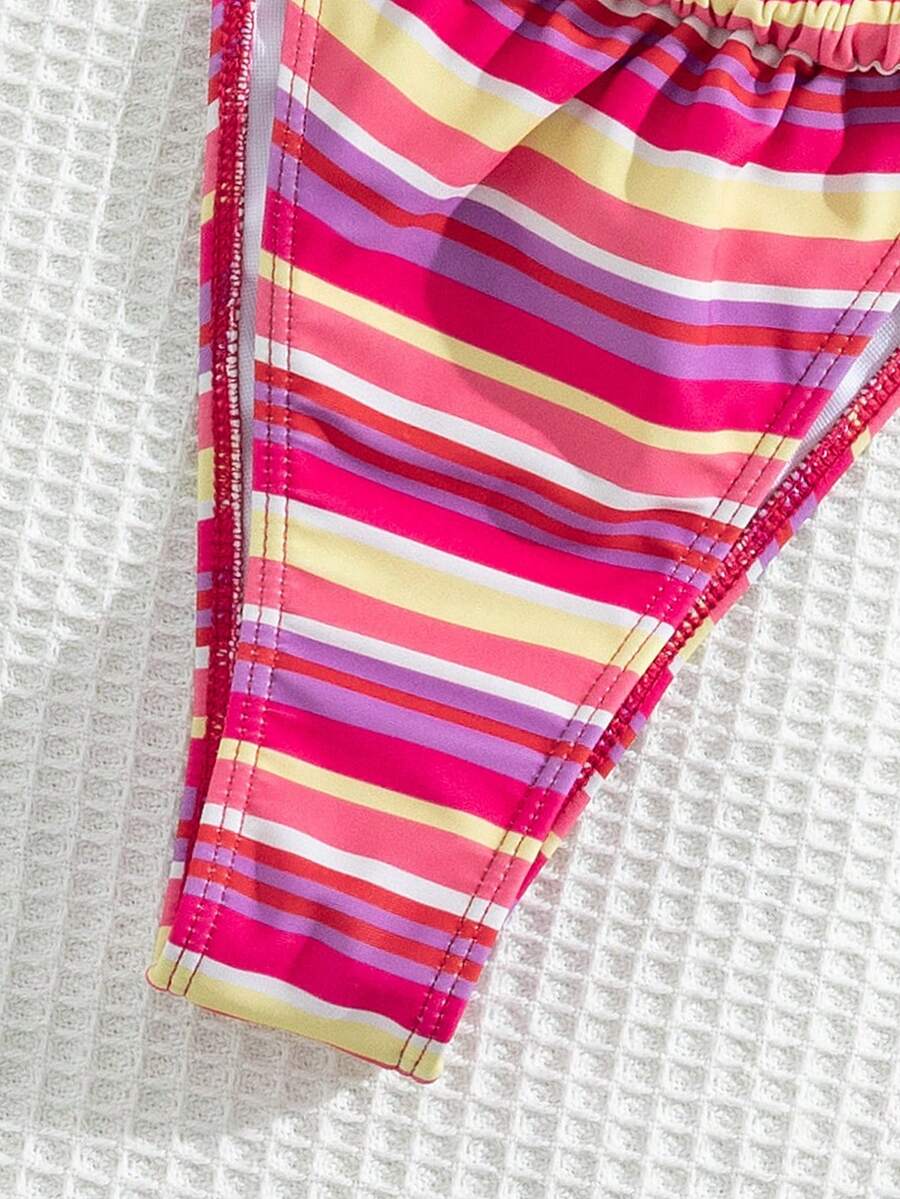 Women's striped halter two-piece swimsuit featuring a lace-up triangle top with removable padding and high-cut low-waist bikini bottoms.