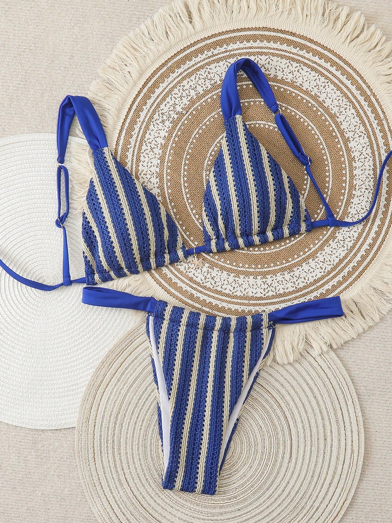 Women's 2-piece triangle cup bikini set in solid color featuring woven pearl shell decoration, halter neckline, and high-waist side-tie ruched bottoms.