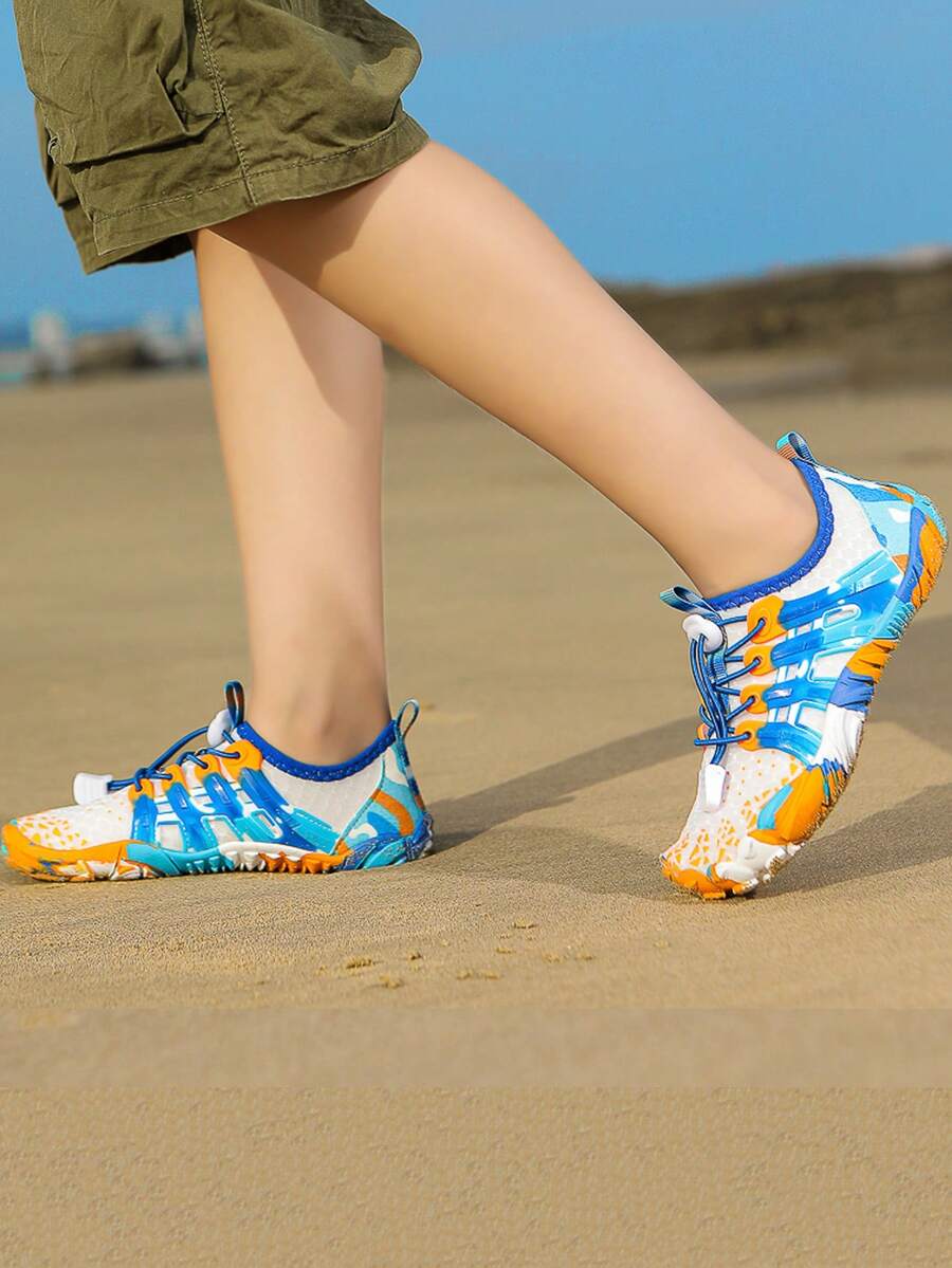 Apricot children's water shoes featuring slip-on fabric uppers, drawstring details, and rubber soles for beach play.