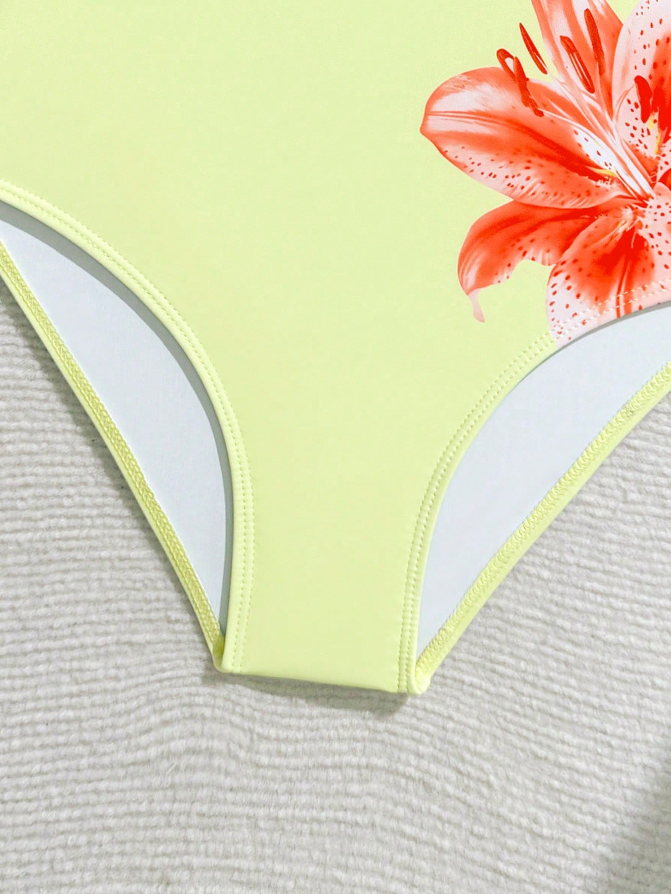 Tween girls one-piece swimsuit with a floral plant print, spaghetti straps, and a mid-waist fit in black.