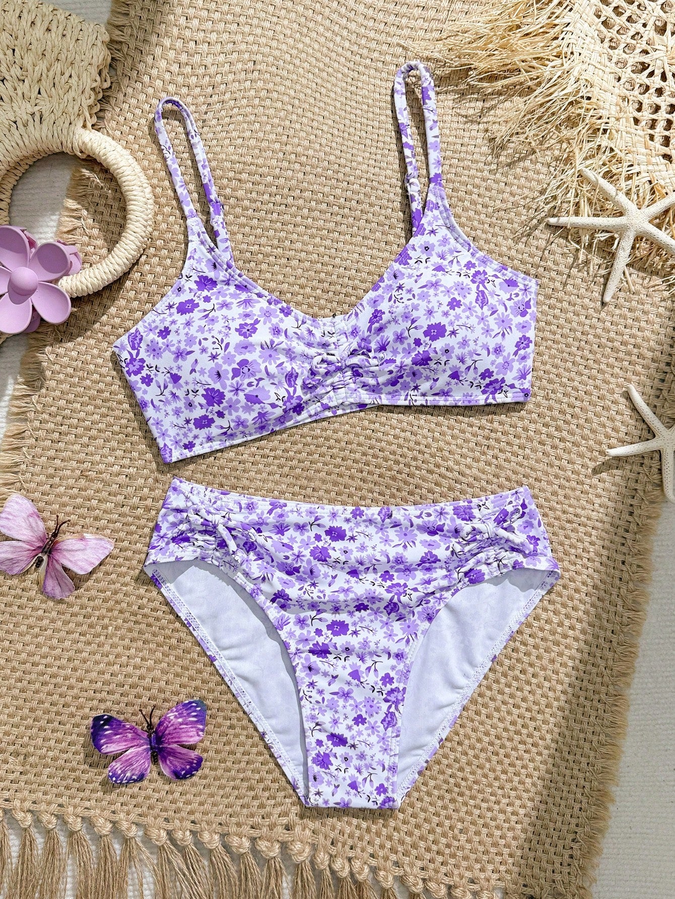 Tween girls 2-piece ditsy floral bikini set featuring a spaghetti strap top with center string detail and matching bottoms with side strings, designed for swimming, vacation, and summer wear.