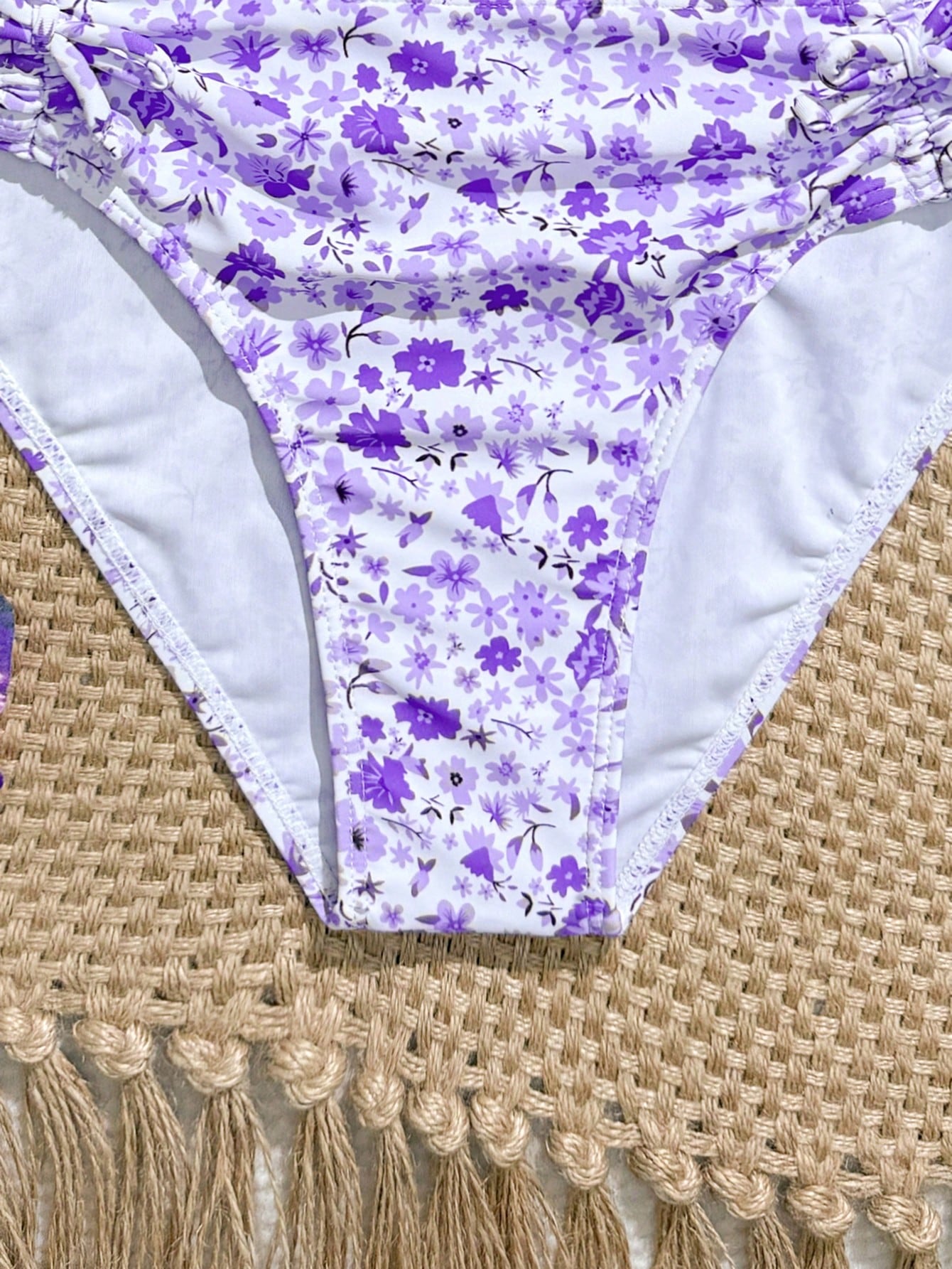 Tween girls 2-piece ditsy floral bikini set featuring a spaghetti strap top with center string detail and matching bottoms with side strings, designed for swimming, vacation, and summer wear.