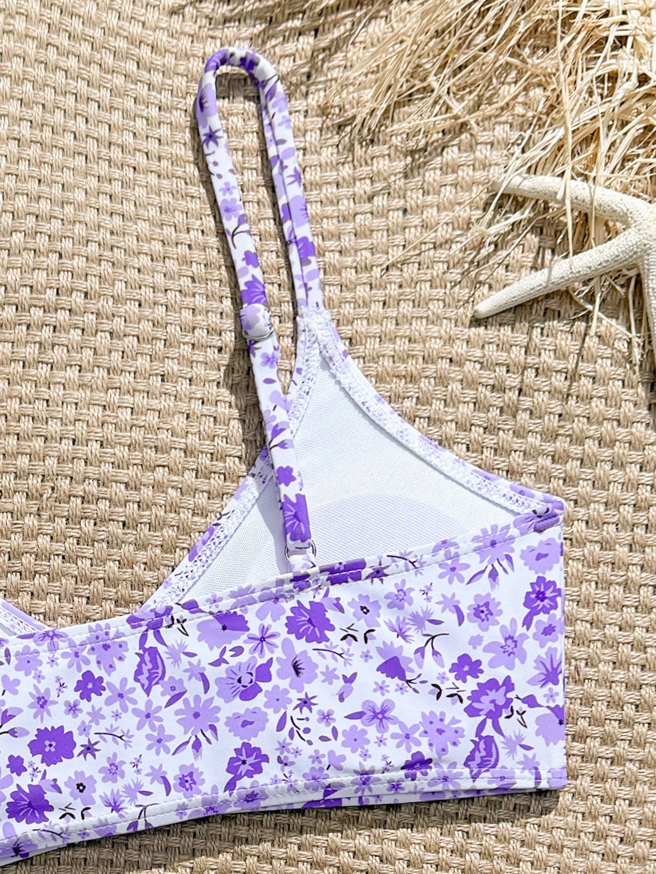 Tween girls 2-piece ditsy floral bikini set featuring a spaghetti strap top with center string detail and matching bottoms with side strings, designed for swimming, vacation, and summer wear.
