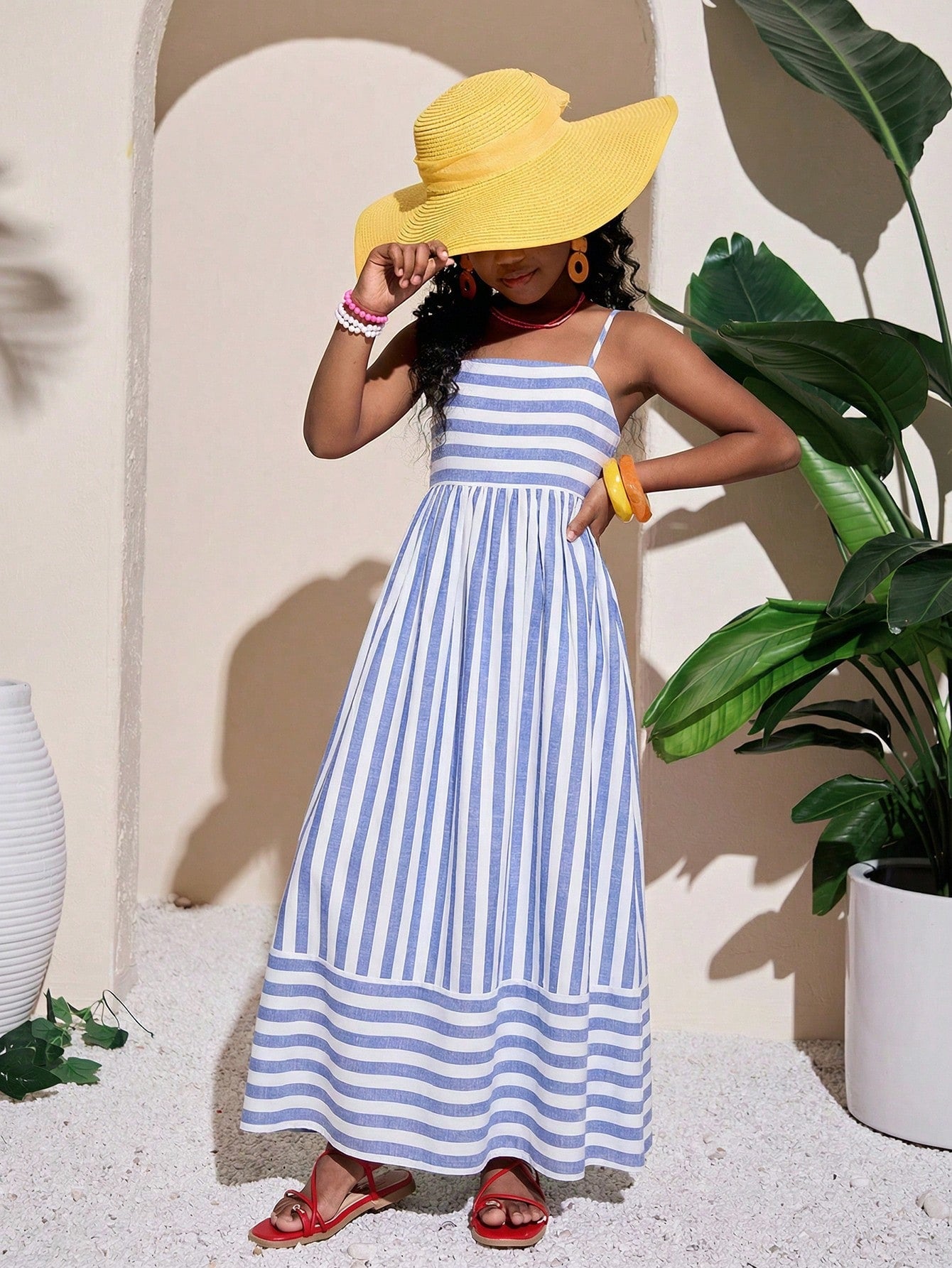 Tween girls striped spaghetti strap cami dress with high waist, shirred detail, zipper closure, sleeveless design, and flared long A-line silhouette for vacation wear.