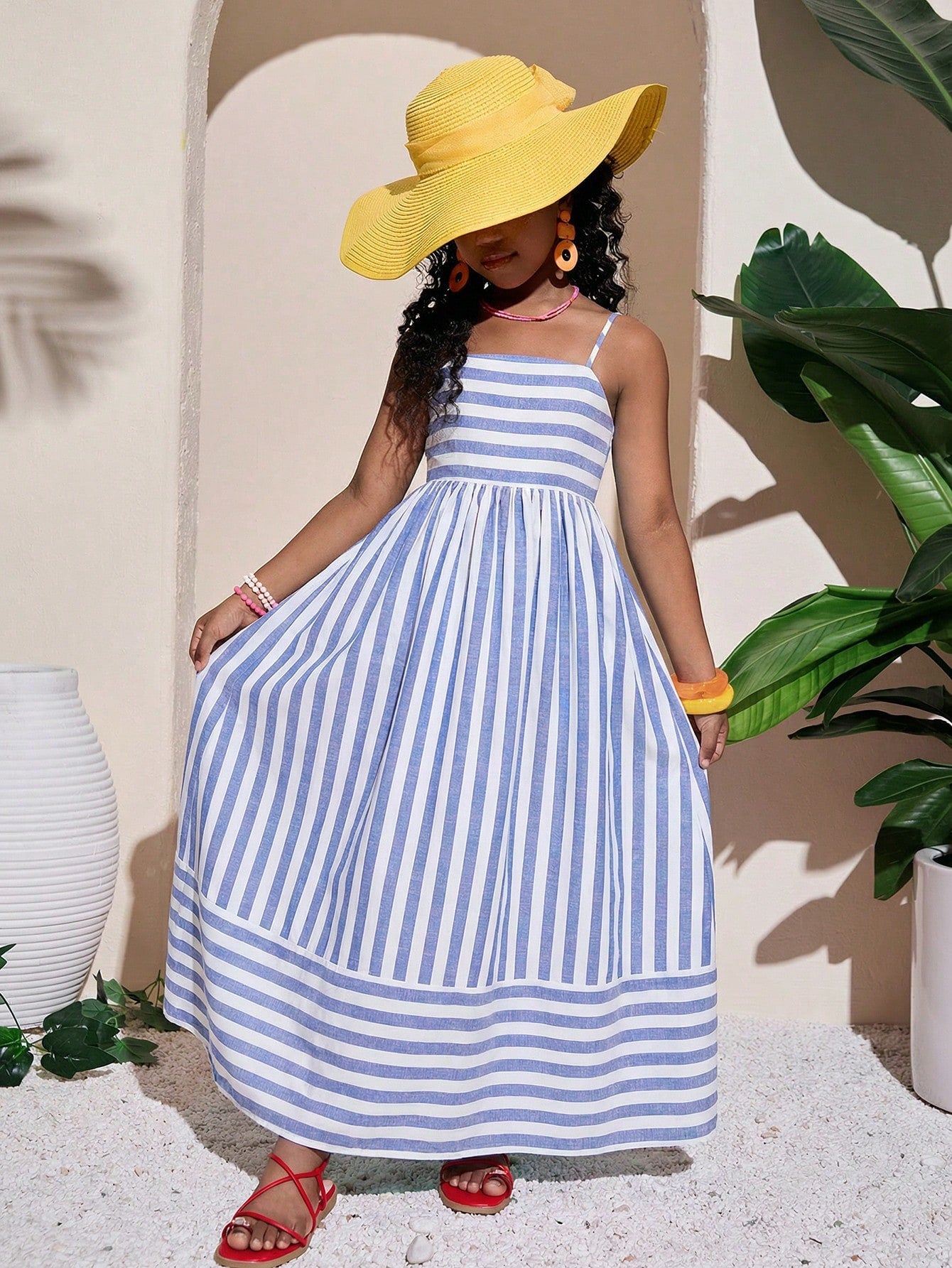 Tween girls striped spaghetti strap cami dress with high waist, shirred detail, zipper closure, sleeveless design, and flared long A-line silhouette for vacation wear.