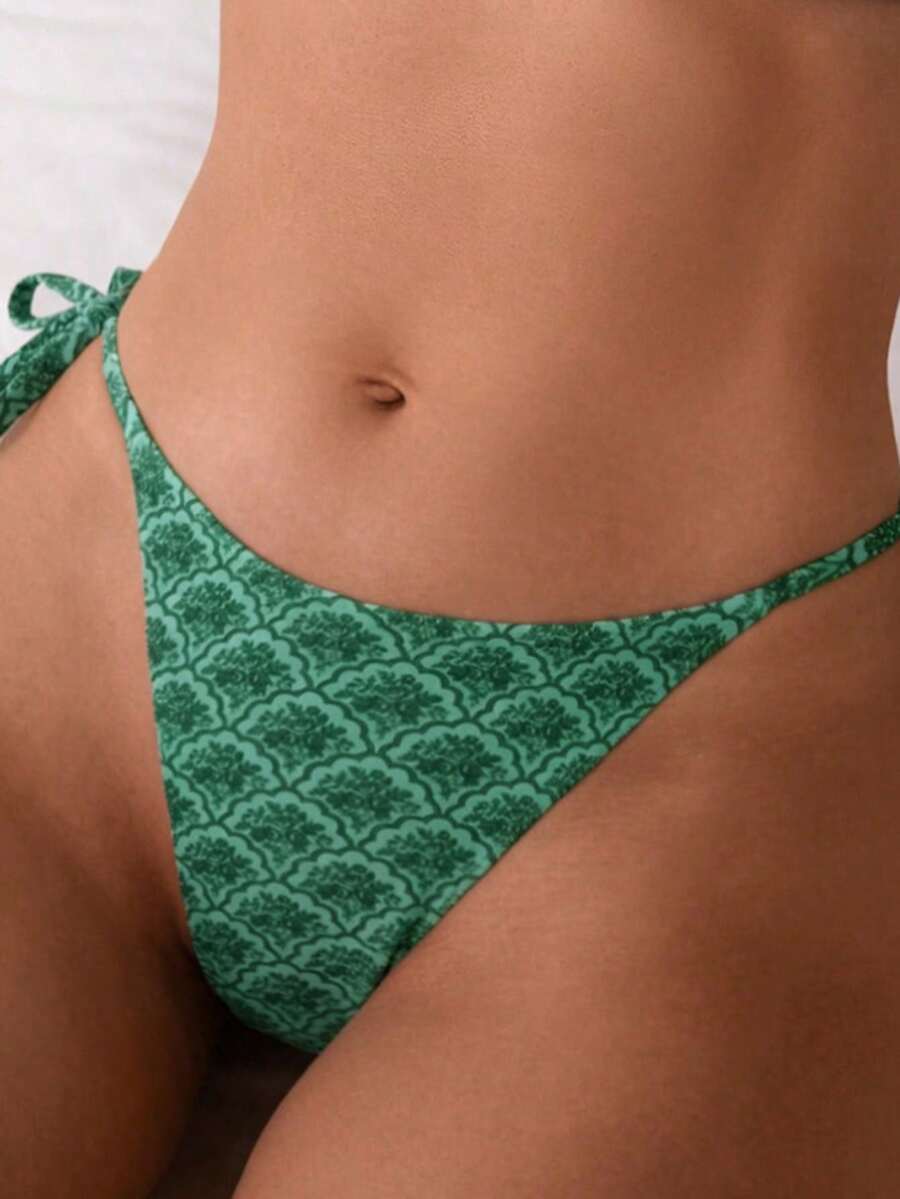 Women's black two-piece bikini set featuring a halter neck with a colorful sun pendant, triangle cups, and high-cut tie-side bottoms.