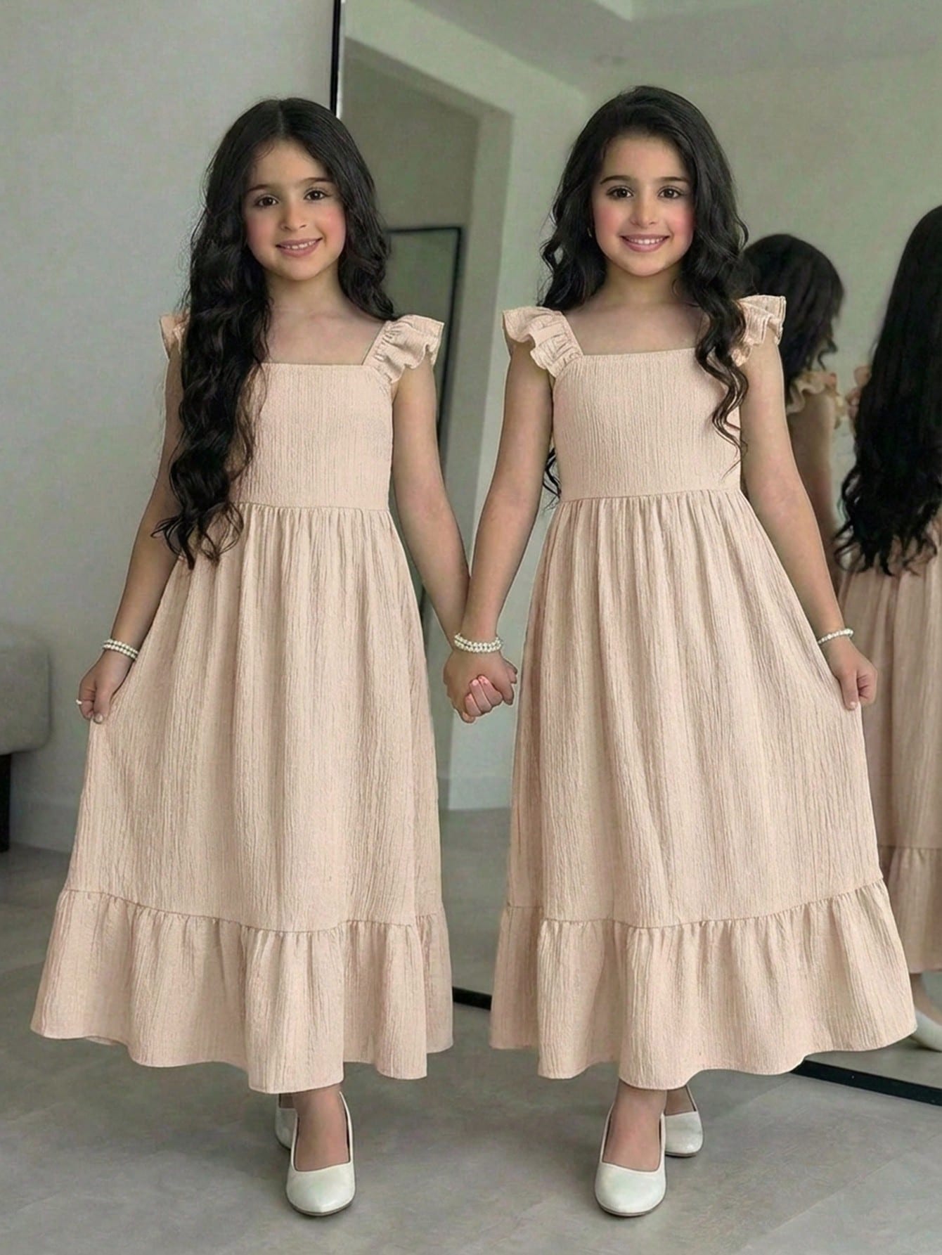 Tween girl multicolor floral vacation dress with square neck, ruffle details, shirred bodice, sleeveless A-line shape, high waist, and flounce hem.