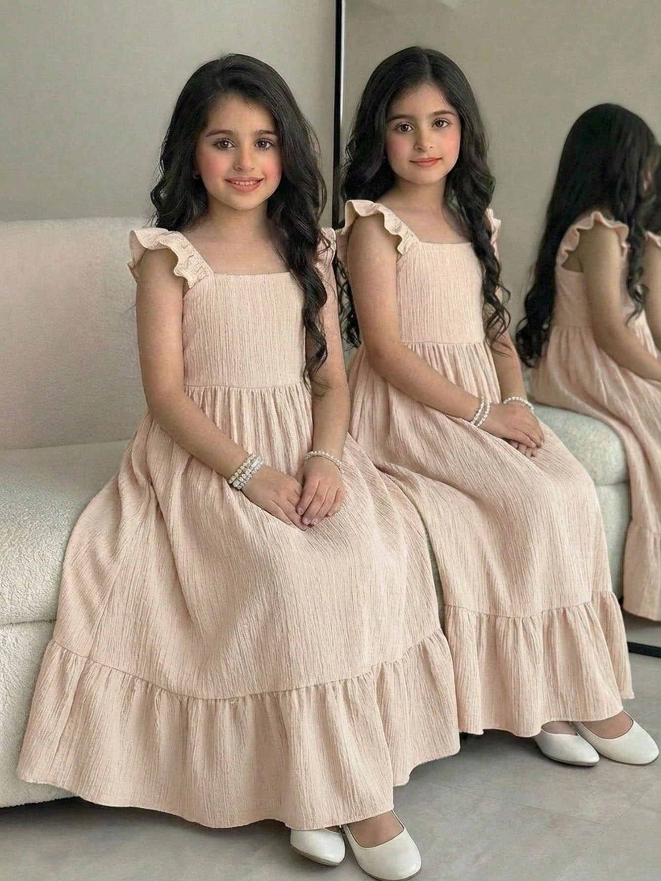 Tween girl multicolor floral vacation dress with square neck, ruffle details, shirred bodice, sleeveless A-line shape, high waist, and flounce hem.
