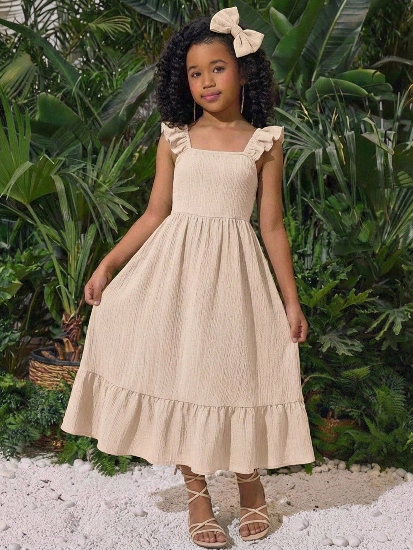Tween girl multicolor floral vacation dress with square neck, ruffle details, shirred bodice, sleeveless A-line shape, high waist, and flounce hem.