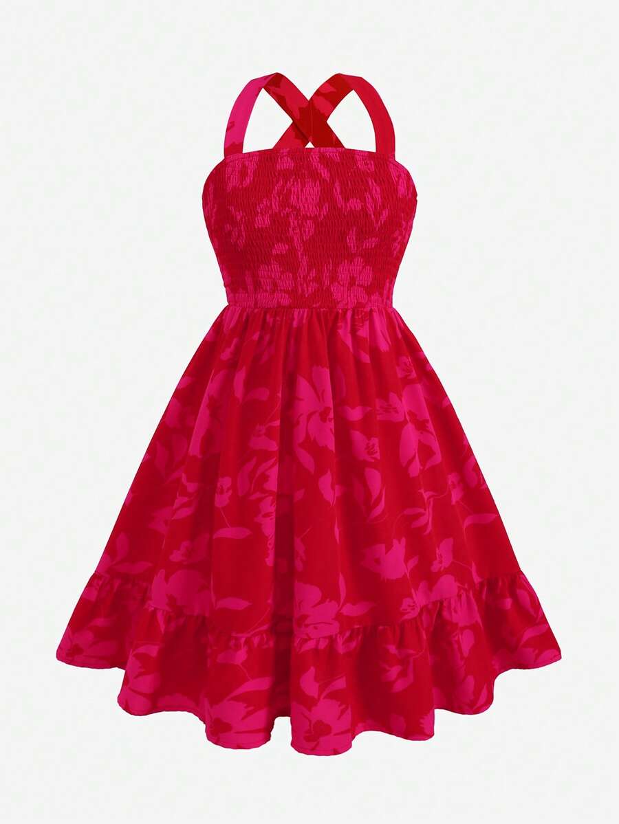 Pink sleeveless tween girls vacation dress with all-over fruit and vegetable print, strap neckline, belted high waist, cut-out detail, and flared ruffle hem.