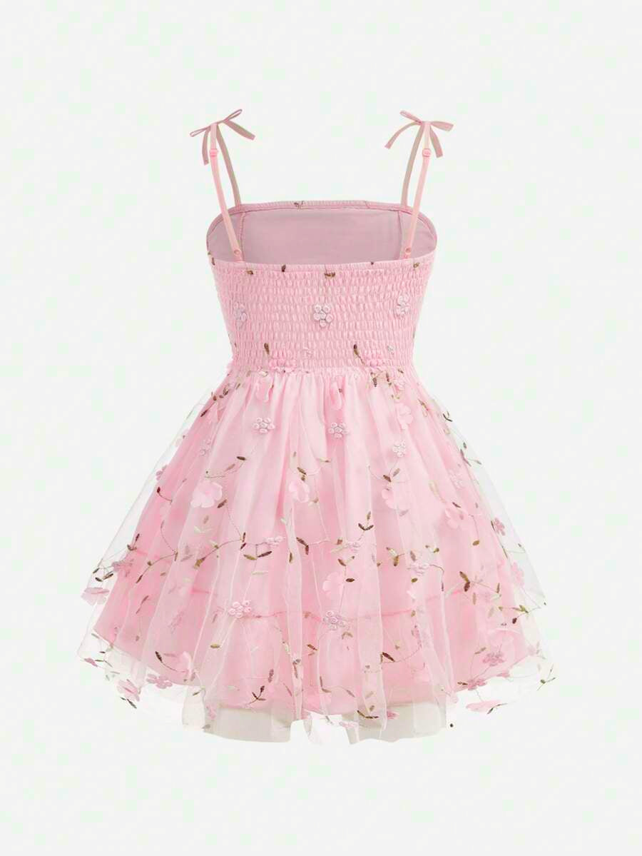 Pink floral print sleeveless cami dress for tween girls featuring spaghetti straps, ruched bust, high waist, and flared short hem.