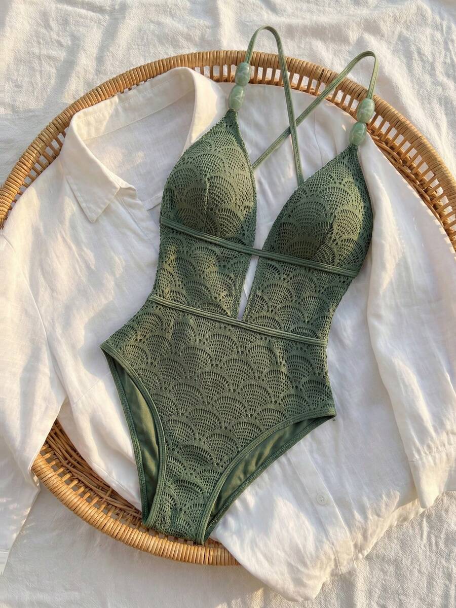 Women's fresh green boho one-piece swimsuit featuring a lace-up V-neckline, textured stretch fabric, and sleeveless design for beach and vacation wear.