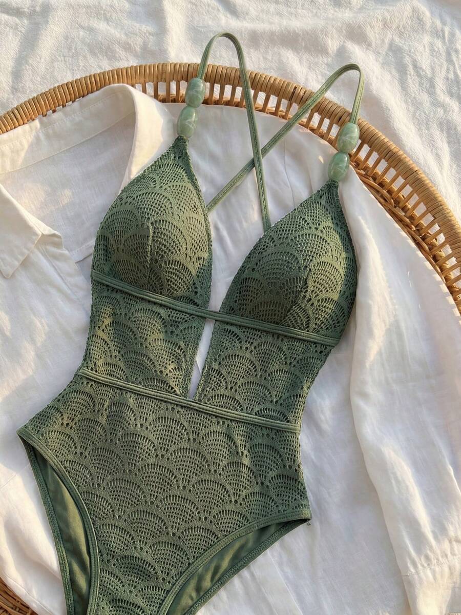Women's fresh green boho one-piece swimsuit featuring a lace-up V-neckline, textured stretch fabric, and sleeveless design for beach and vacation wear.