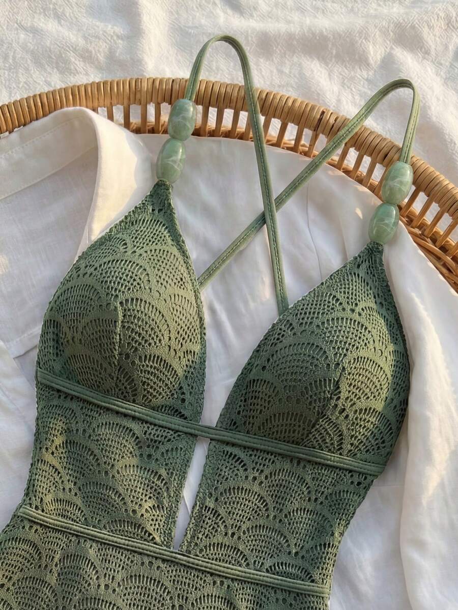 Women's fresh green boho one-piece swimsuit featuring a lace-up V-neckline, textured stretch fabric, and sleeveless design for beach and vacation wear.