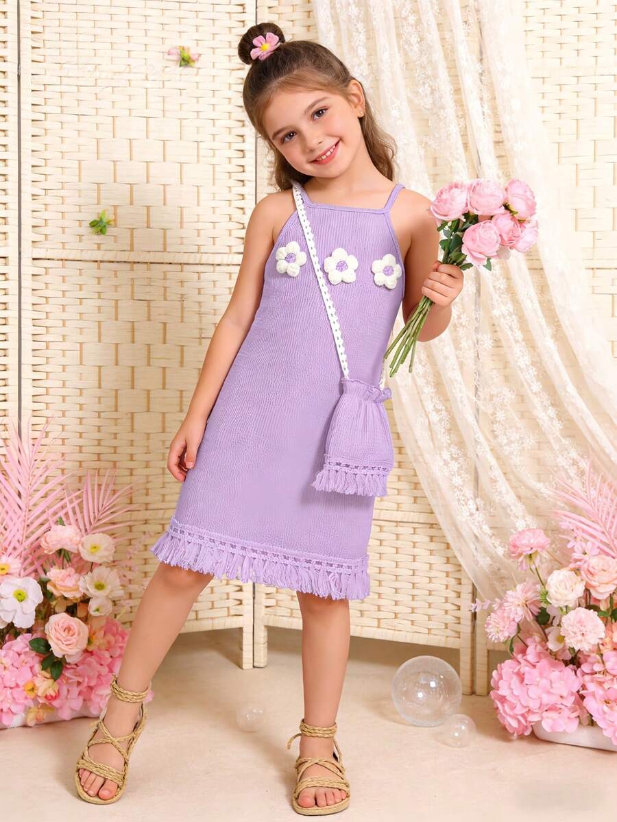 Girls' sleeveless summer midi dress with halter neckline, geometric pattern, applique and fringe details, shown with crossbody bag accessory with tassel decor