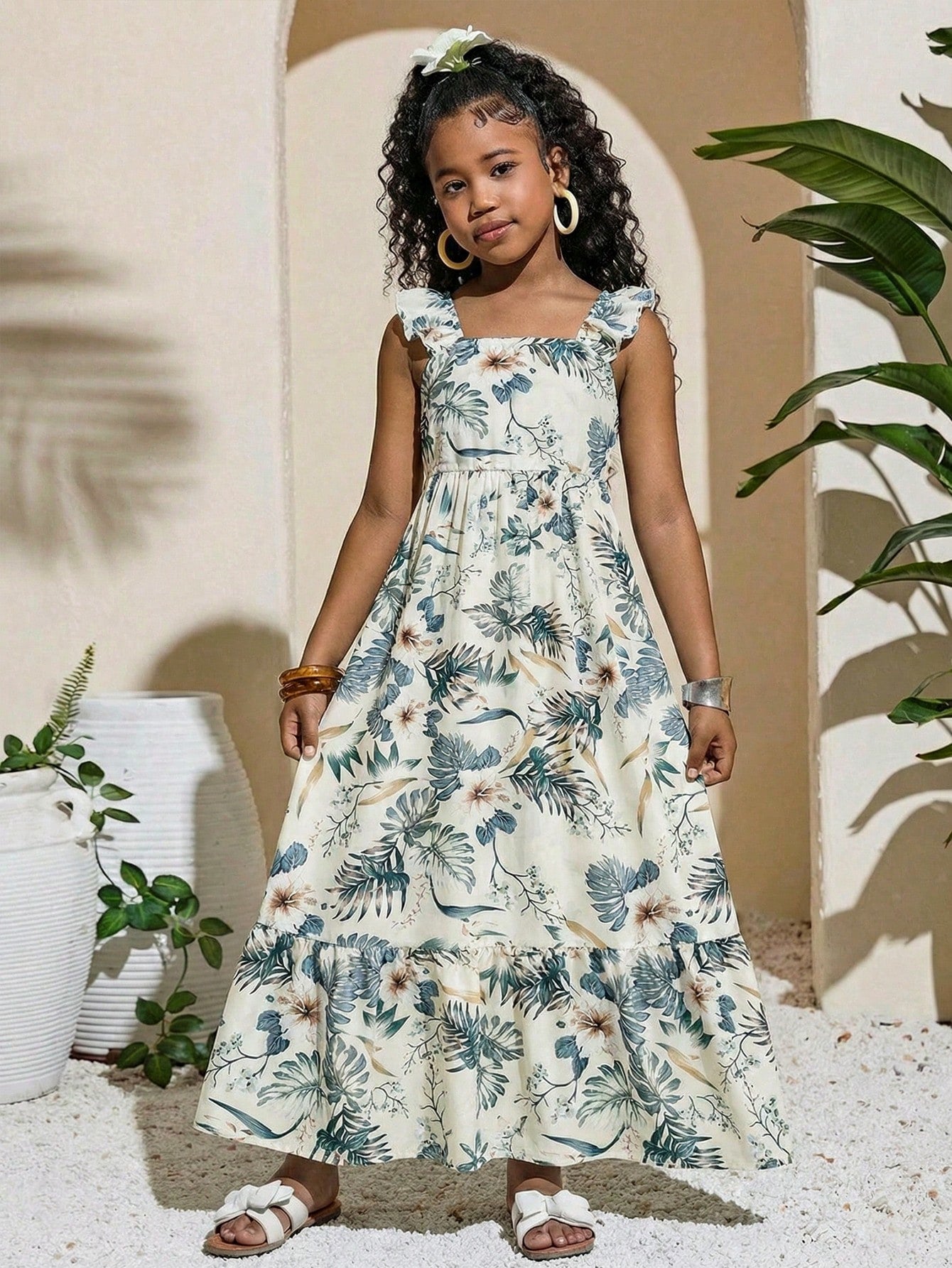 Tween girl multicolor floral vacation dress with square neck, ruffle details, shirred bodice, sleeveless A-line shape, high waist, and flounce hem.