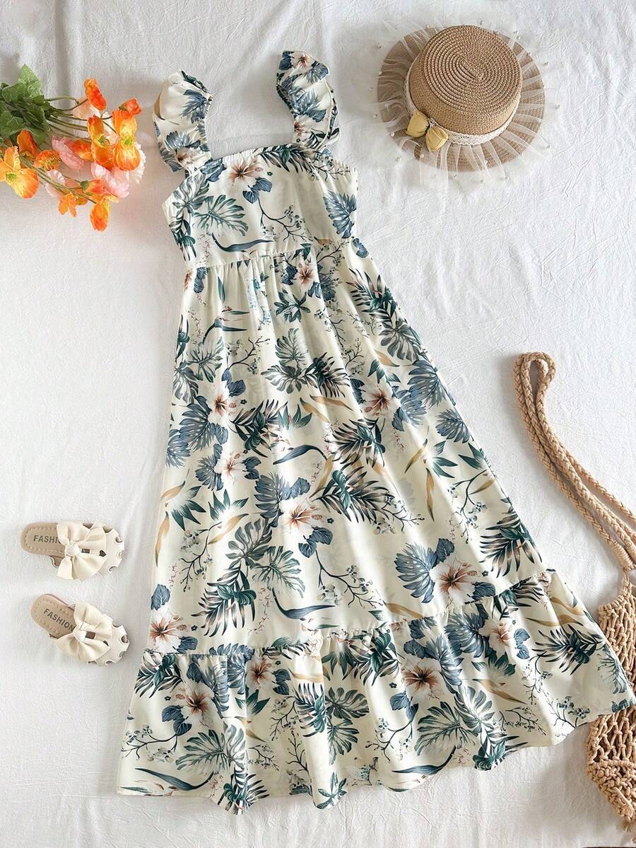 Blue floral print long vacation dress for tween girls featuring an A-line high waist silhouette with ruffle details and spaghetti straps.