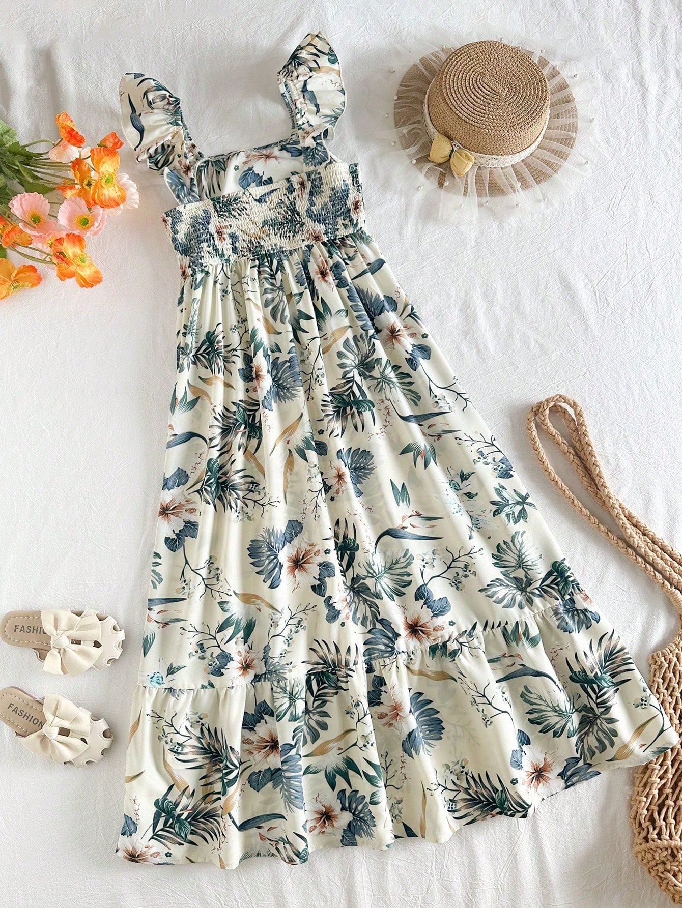 Tween girl multicolor floral vacation dress with square neck, ruffle details, shirred bodice, sleeveless A-line shape, high waist, and flounce hem.
