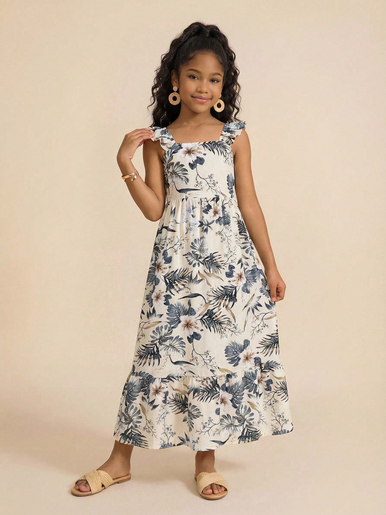 Tween girl multicolor floral vacation dress with square neck, ruffle details, shirred bodice, sleeveless A-line shape, high waist, and flounce hem.